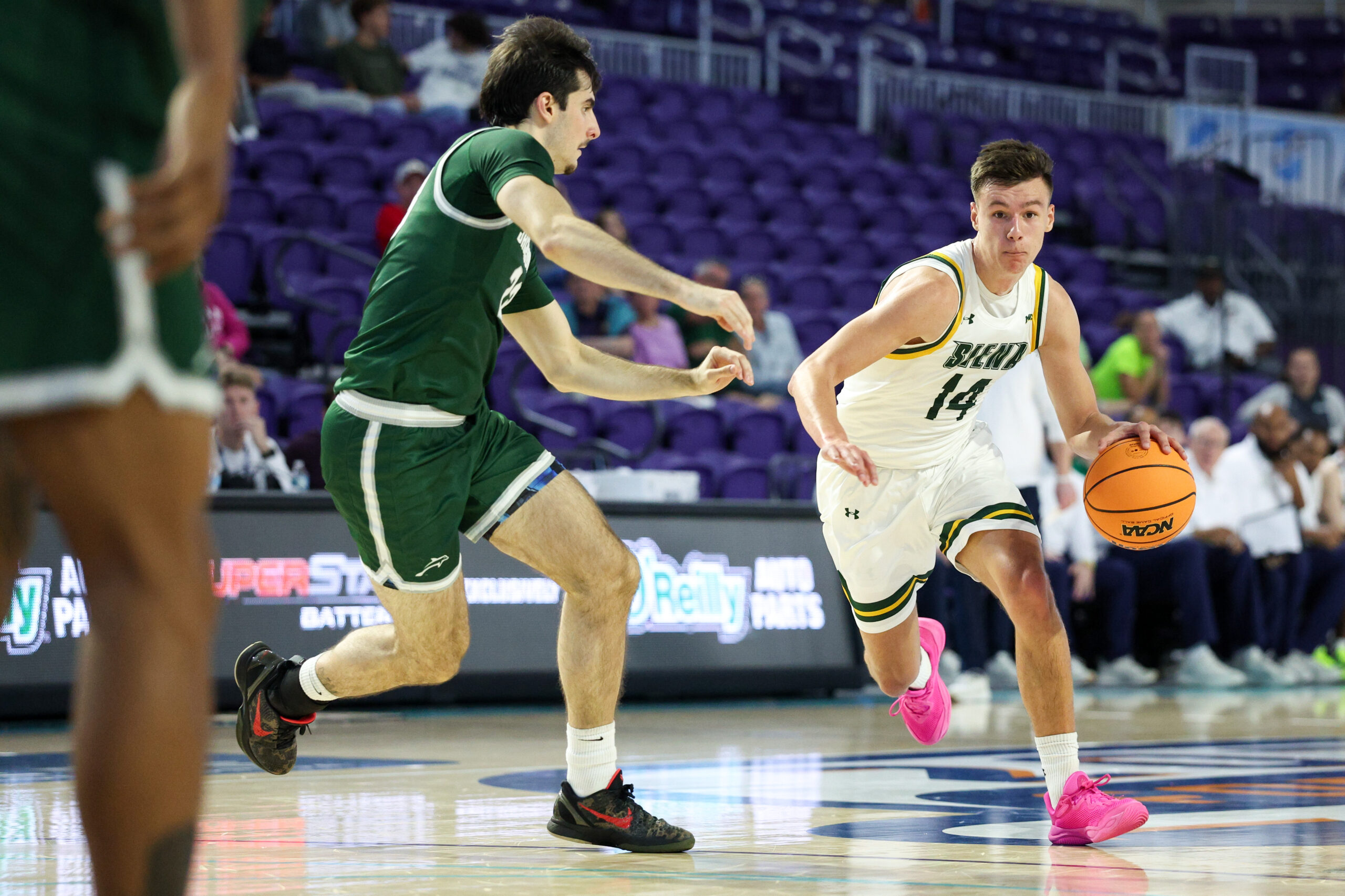 Nov 26, 2024; Fort Myers, Florida, USA; Siena Saints guard Gavin Doty (14) drives to teh basket against the Jacksonville Dolphins in the first half at Suncoast Credit Union Arena. Mandatory Credit: Nathan Ray Seebeck-Imagn Images
