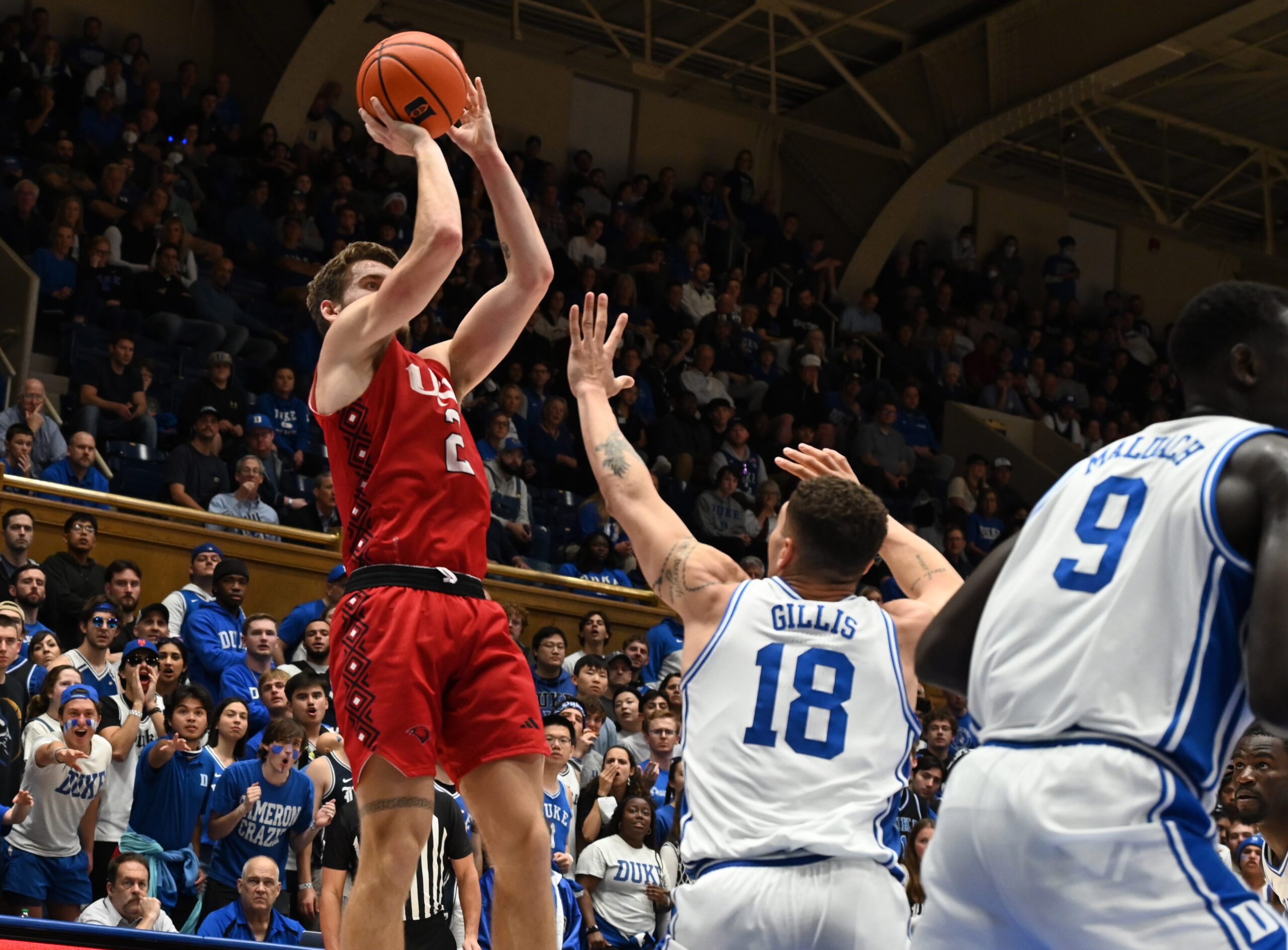 Dec 10, 2024; Durham, North Carolina, USA;  dIncarnate Word Cardinals forward Dylan Hayman (2) shoots over Duke Blue Devils forward Mason Gillis (18) during the first half at Cameron Indoor Stadium. Mandatory Credit: Rob Kinnan-Imagn Images