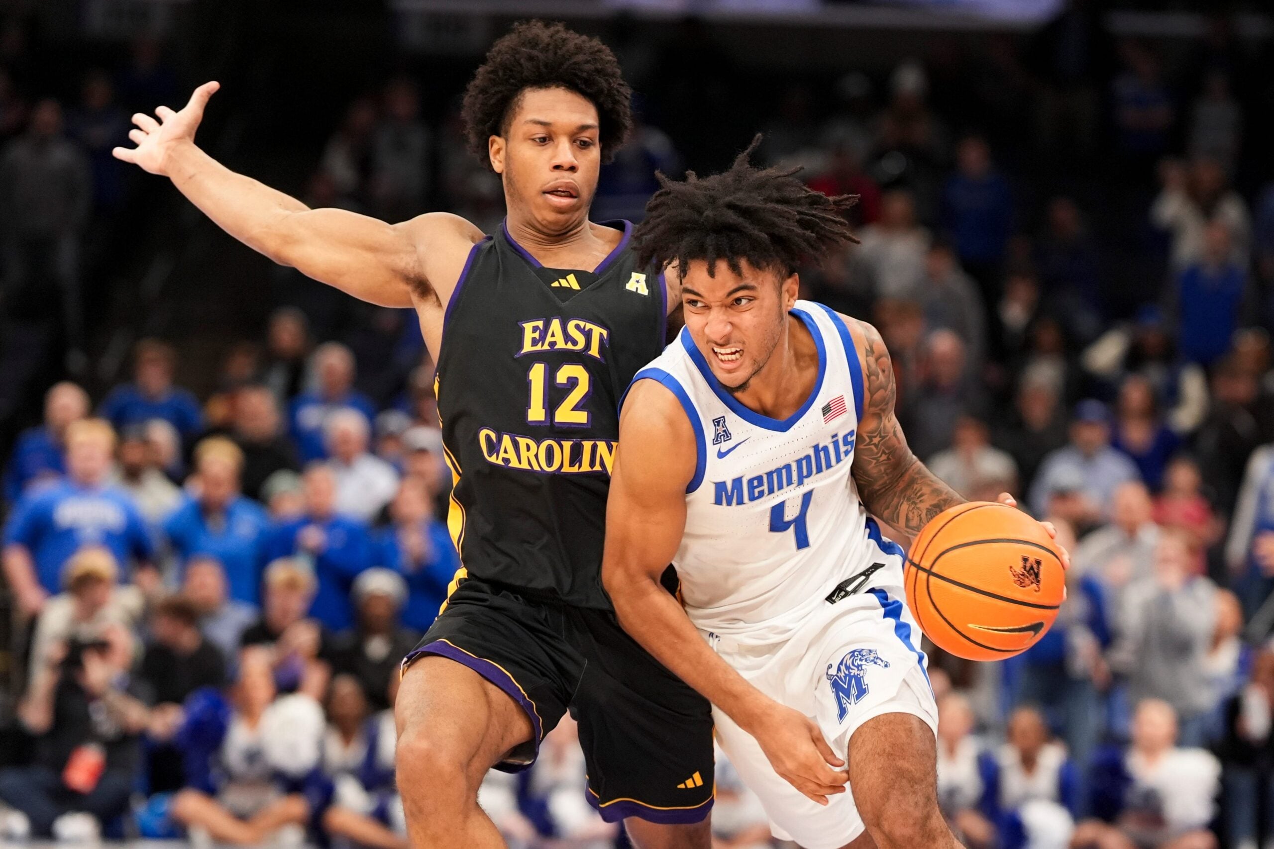 Memphis' PJ Haggerty (4) drives to the basket as East Carolina's Jordan Riley (12) guards him during the game between East Carolina University and University of Memphis at FedExForum in Memphis, Tenn., on Saturday, January 11, 2025.