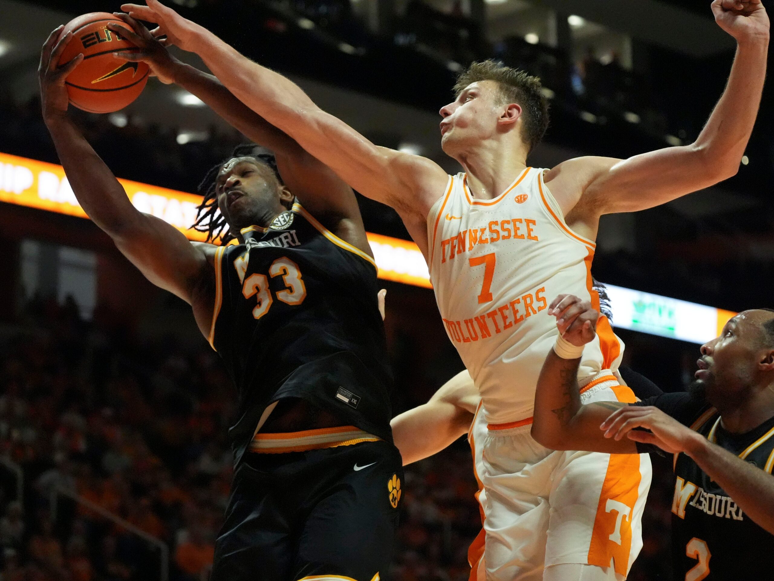 Missouri's Josh Gray (33) gets the rebound over Tennessee's Igor Miličić Jr. (7) during an NCAA college basketball game on Wednesday, Feb. 5, 2025, in Knoxville, Tenn.