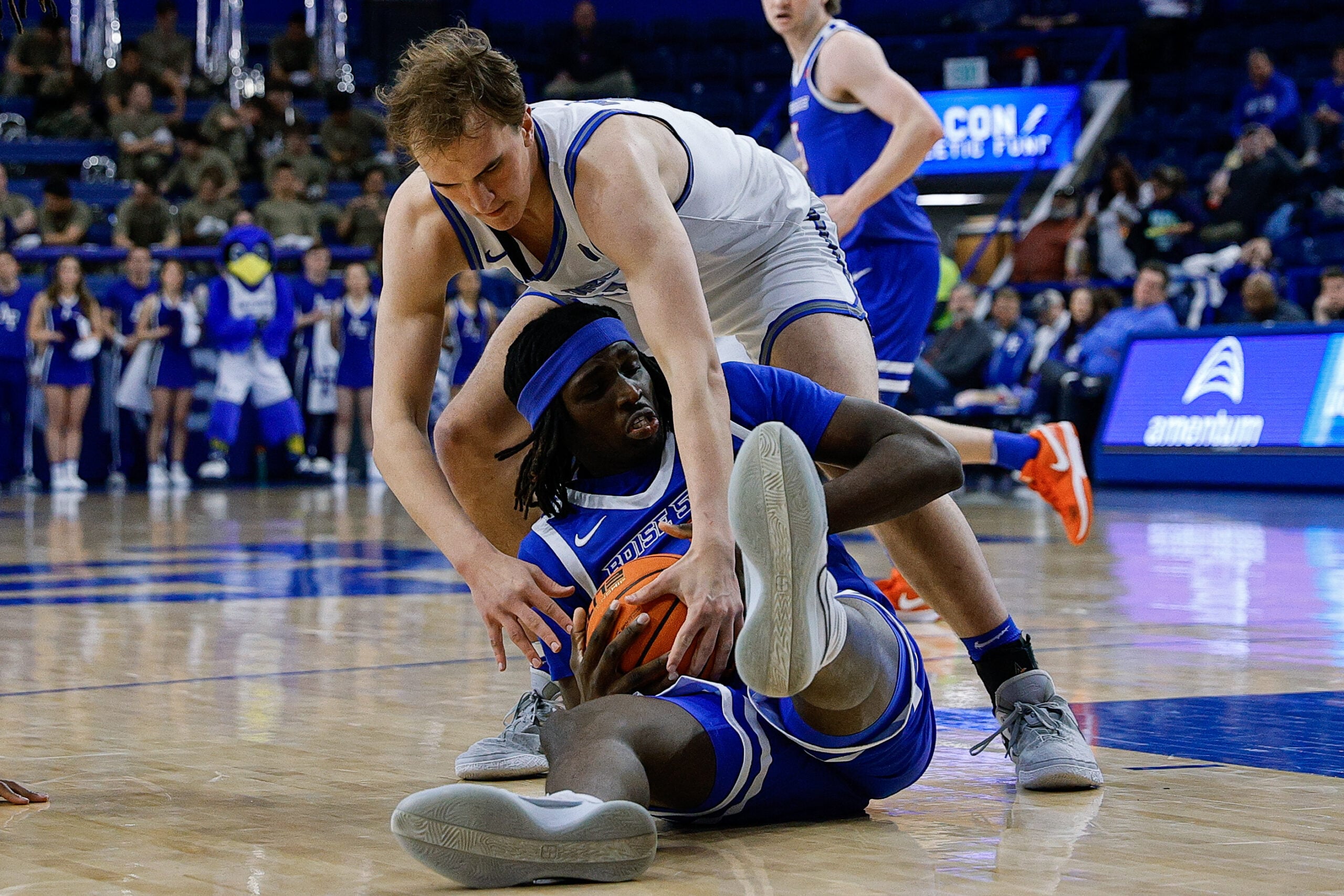 Mar 4, 2025; Colorado Springs, Colorado, USA; Boise State Broncos forward O'Mar Stanley (1) and Air Force Falcons center Wesley Celichowski (51) battle for the ball in the second half at Clune Arena. Mandatory Credit: Isaiah J. Downing-Imagn Images