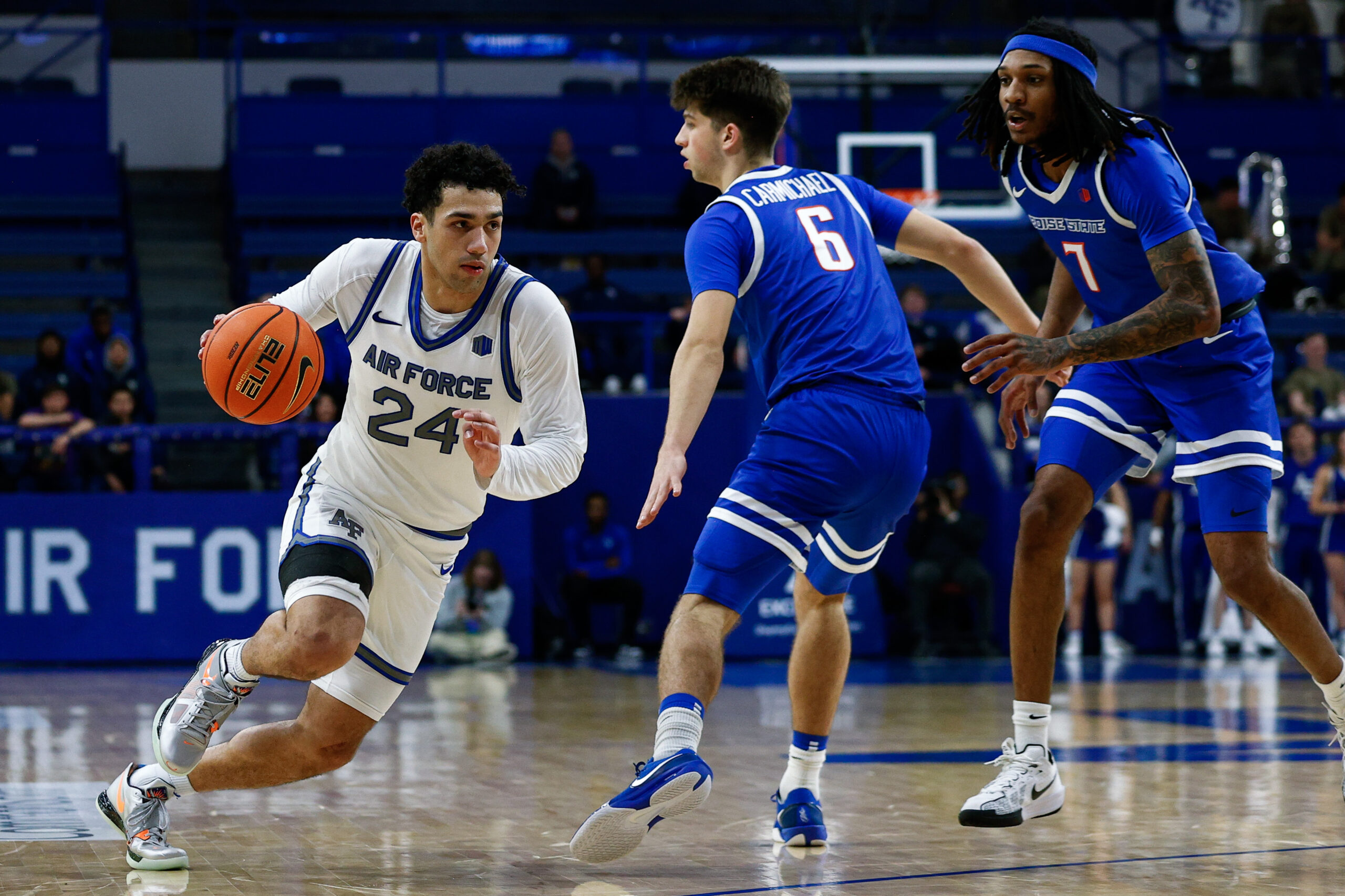 Mar 4, 2025; Colorado Springs, Colorado, USA; Air Force Falcons guard Jeffrey Mills (24) drives to the basket against Boise State Broncos forward Pearson Carmichael (6) and guard Chris Lockett Jr. (7) in the second half at Clune Arena. Mandatory Credit: Isaiah J. Downing-Imagn Images