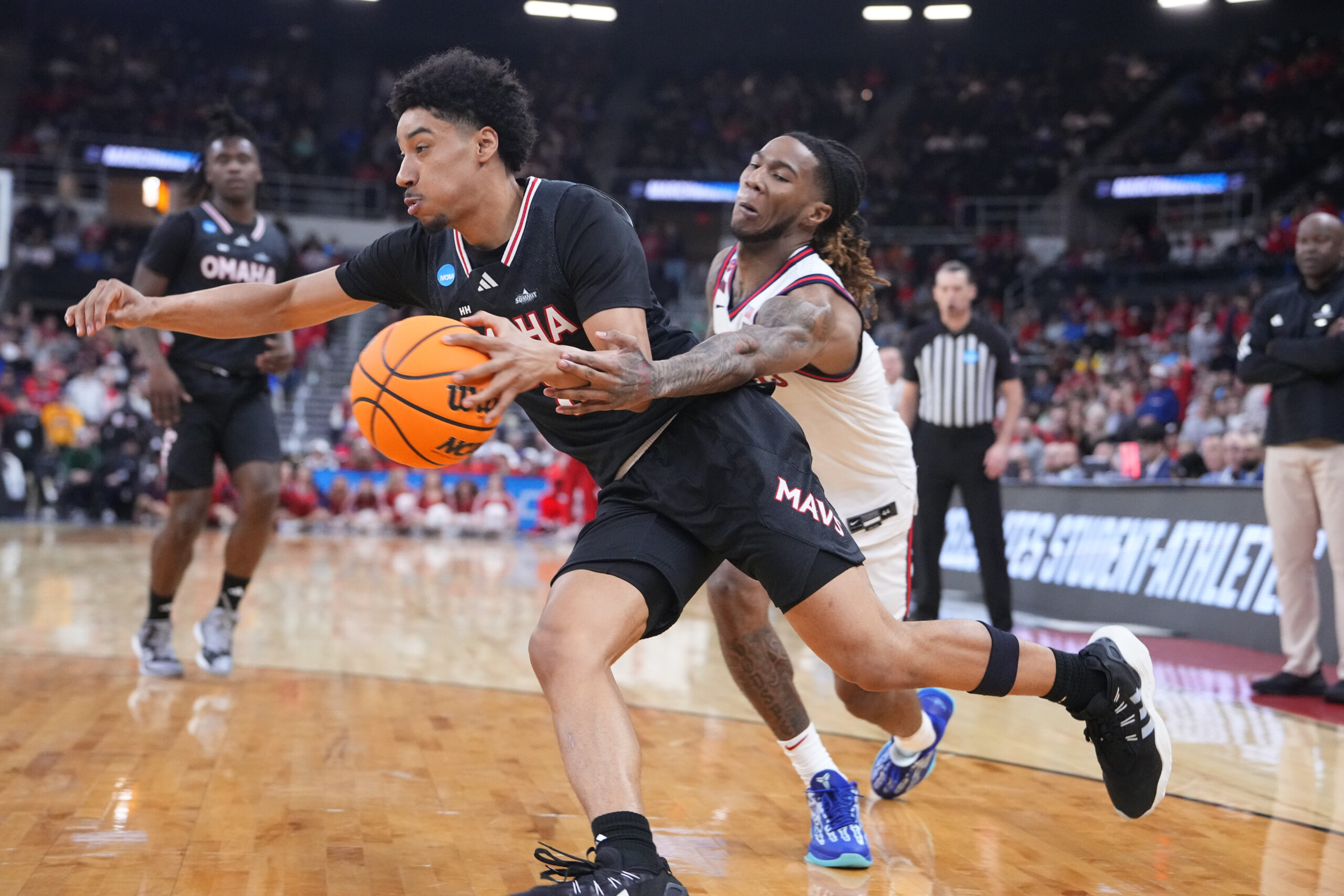 Mar 20, 2025; Providence, RI, USA;  Omaha Mavericks guard Lance Waddles (7) controls the ball against St. John's Red Storm guard Deivon Smith (5) during the second half at Amica Mutual Pavilion. Mandatory Credit: Gregory Fisher-Imagn Images