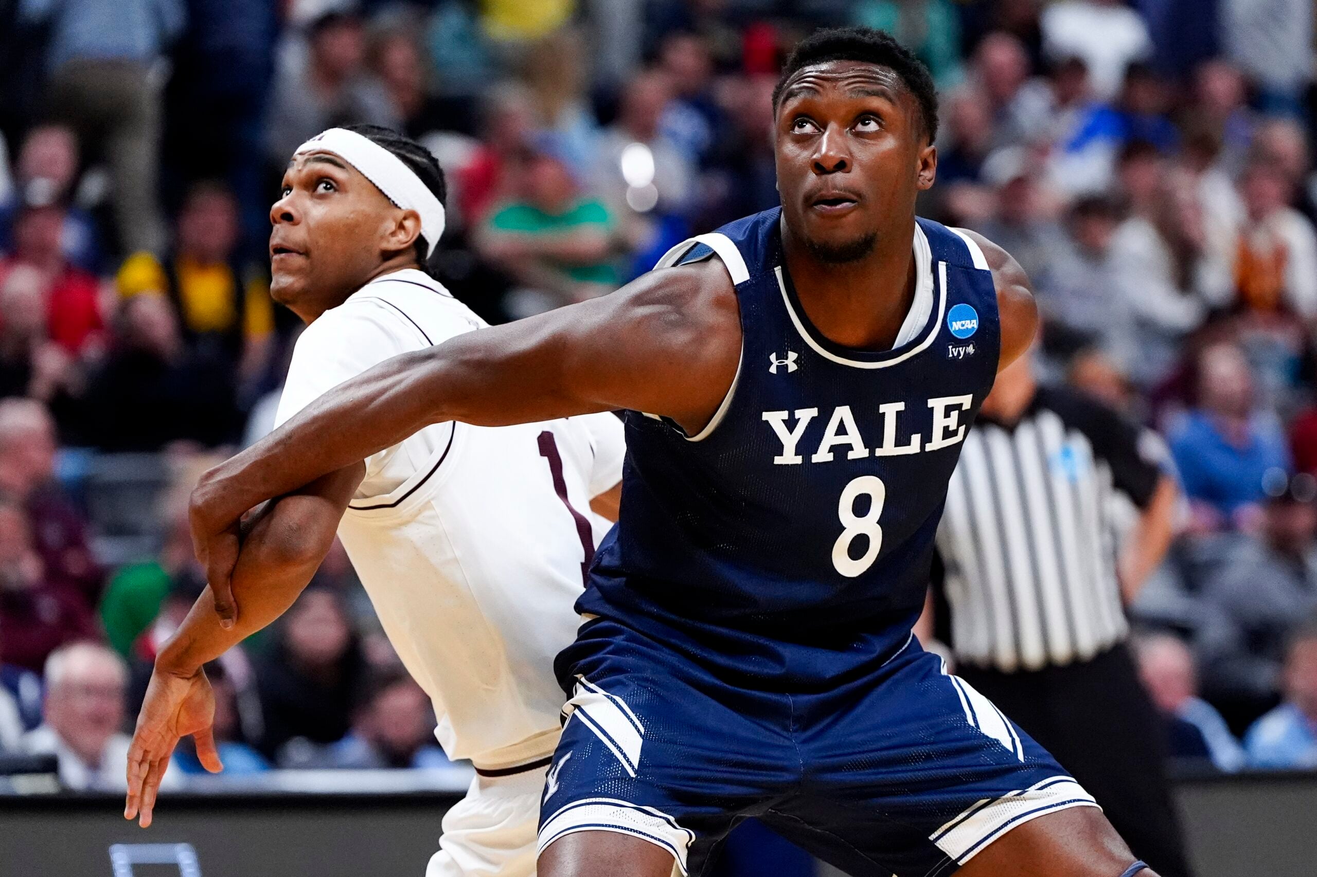 March 20, 2025; Denver, CO, USA; Yale Bulldogs forward Isaac Celiscar (8) boxes out Texas A&M Aggies guard Zhuric Phelps (1) during the second half at Ball Arena. Mandatory Credit: Ron Chenoy-Imagn Images