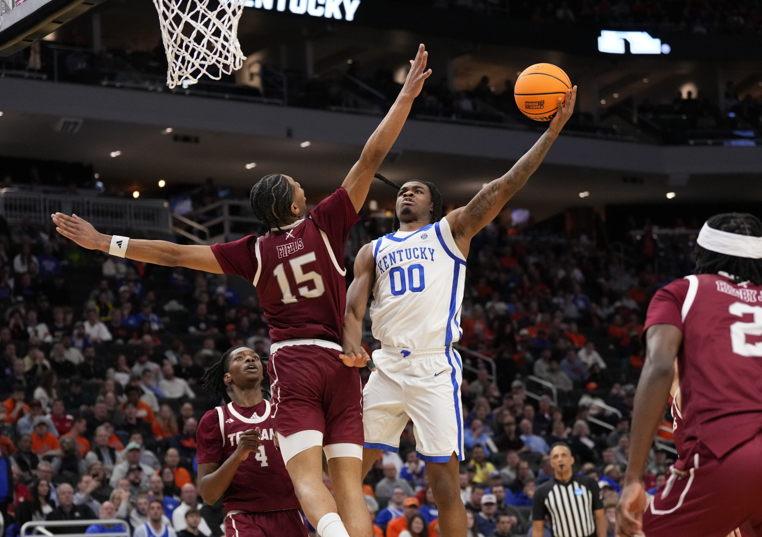 Mar 21, 2025; Milwaukee, WI, USA; Kentucky Wildcats guard Otega Oweh (00) drives to the hoop past Troy Trojans forward Jackson Fields (15) during the second half at Fiserv Forum. Mandatory Credit: Jeff Hanisch-Imagn Images