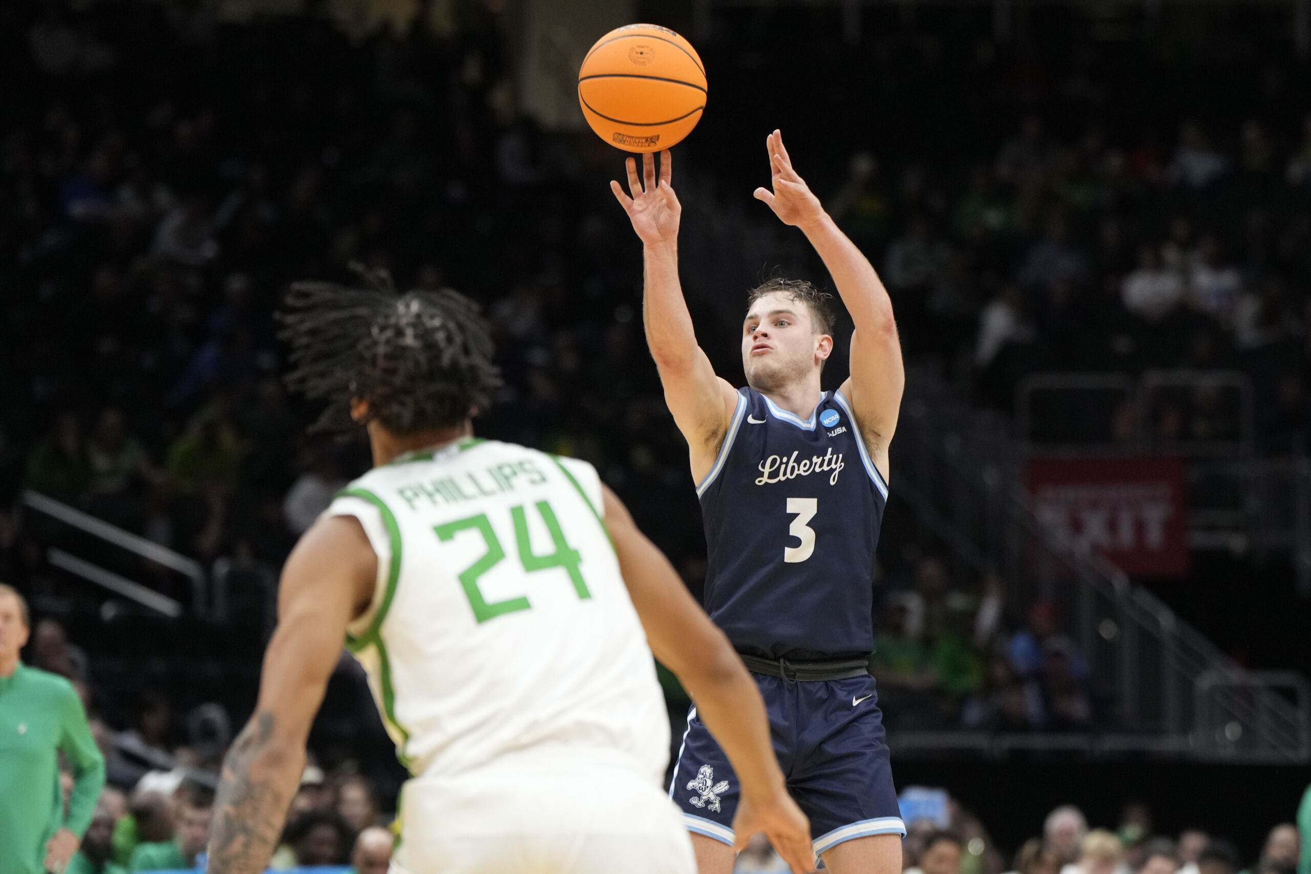 Mar 21, 2025; Seattle, WA, USA; Liberty Flames guard Kaden Metheny (3) shoots the ball against Oregon Ducks guard Jamari Phillips (24) during the second half in the first round of the NCAA Tournament  at Climate Pledge Arena. Mandatory Credit: Stephen Brashear-Imagn Images