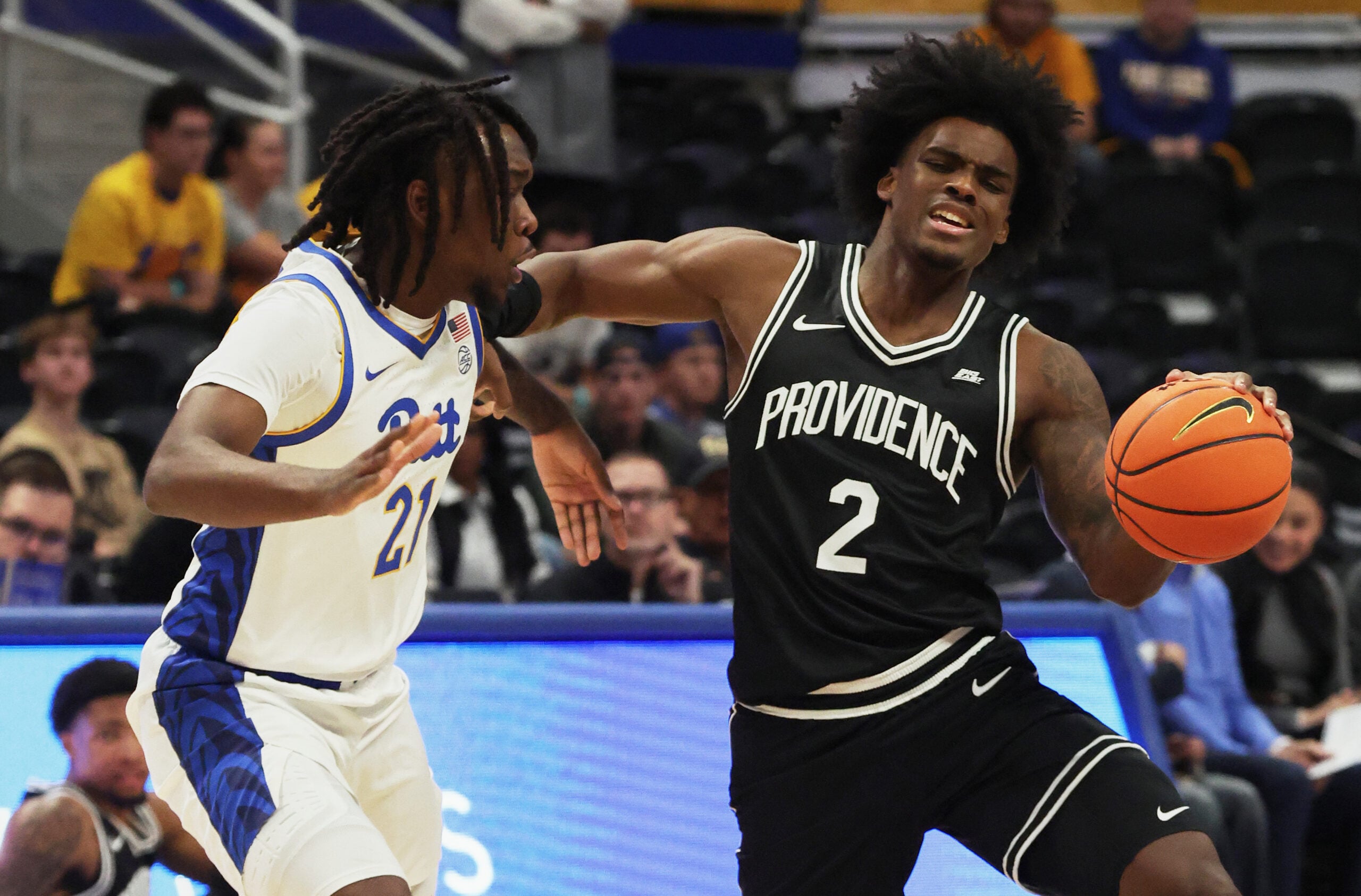 Oct 19, 2025; Pittsburgh, PA, USA;  Providence Friars guard Jaylin Sellers (2) controls the ball against Pittsburgh Panthers guard Macari Moore (21) during the first half at the Petersen Events Center. Mandatory Credit: Charles LeClaire-Imagn Images