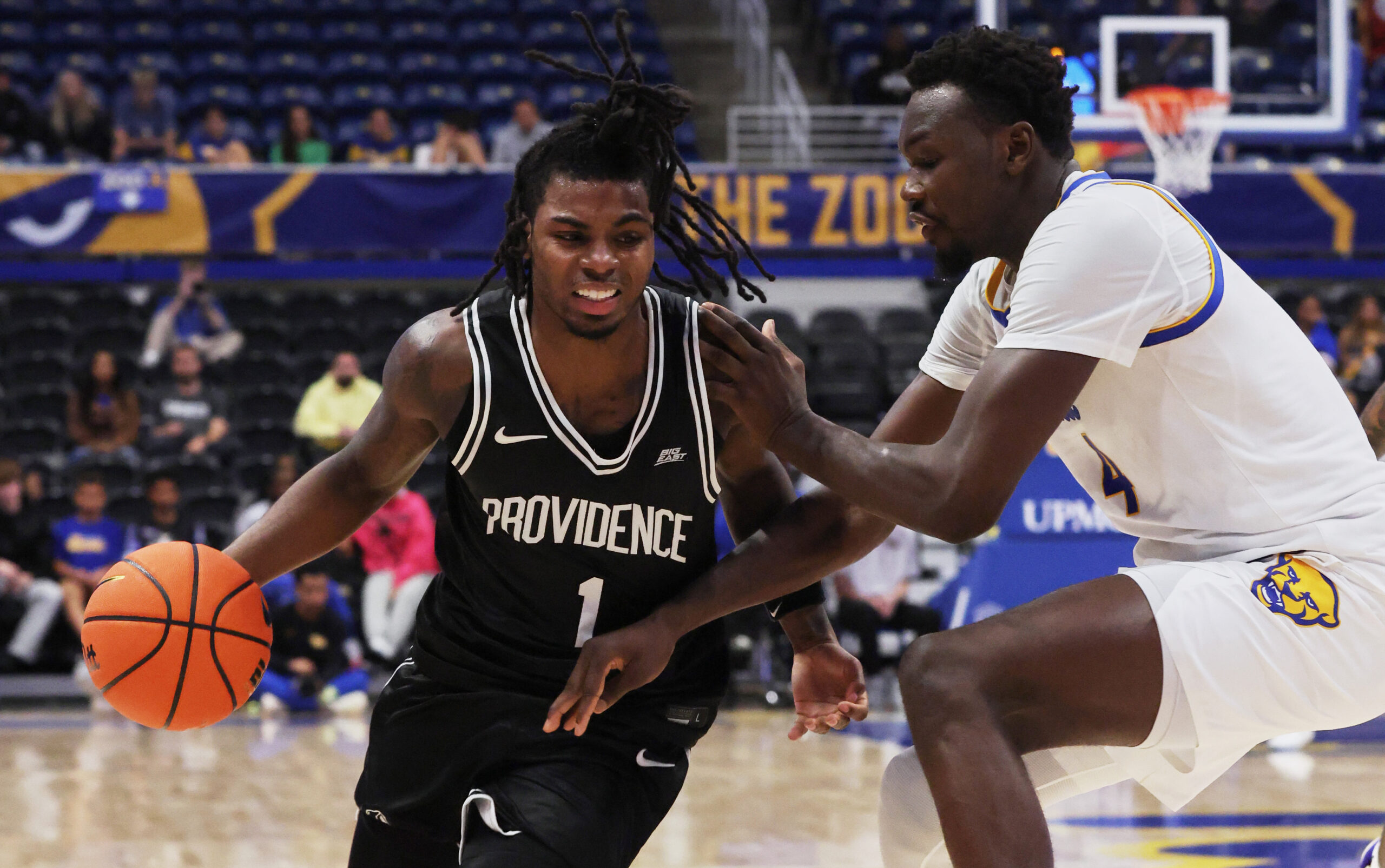 Oct 19, 2025; Pittsburgh, PA, USA; Providence Friars guard Jason Edwards (1) drives to the basket against Pittsburgh Panthers forward Papa Amadou Kante (4) during the second half at the Petersen Events Center. Mandatory Credit: Charles LeClaire-Imagn Images