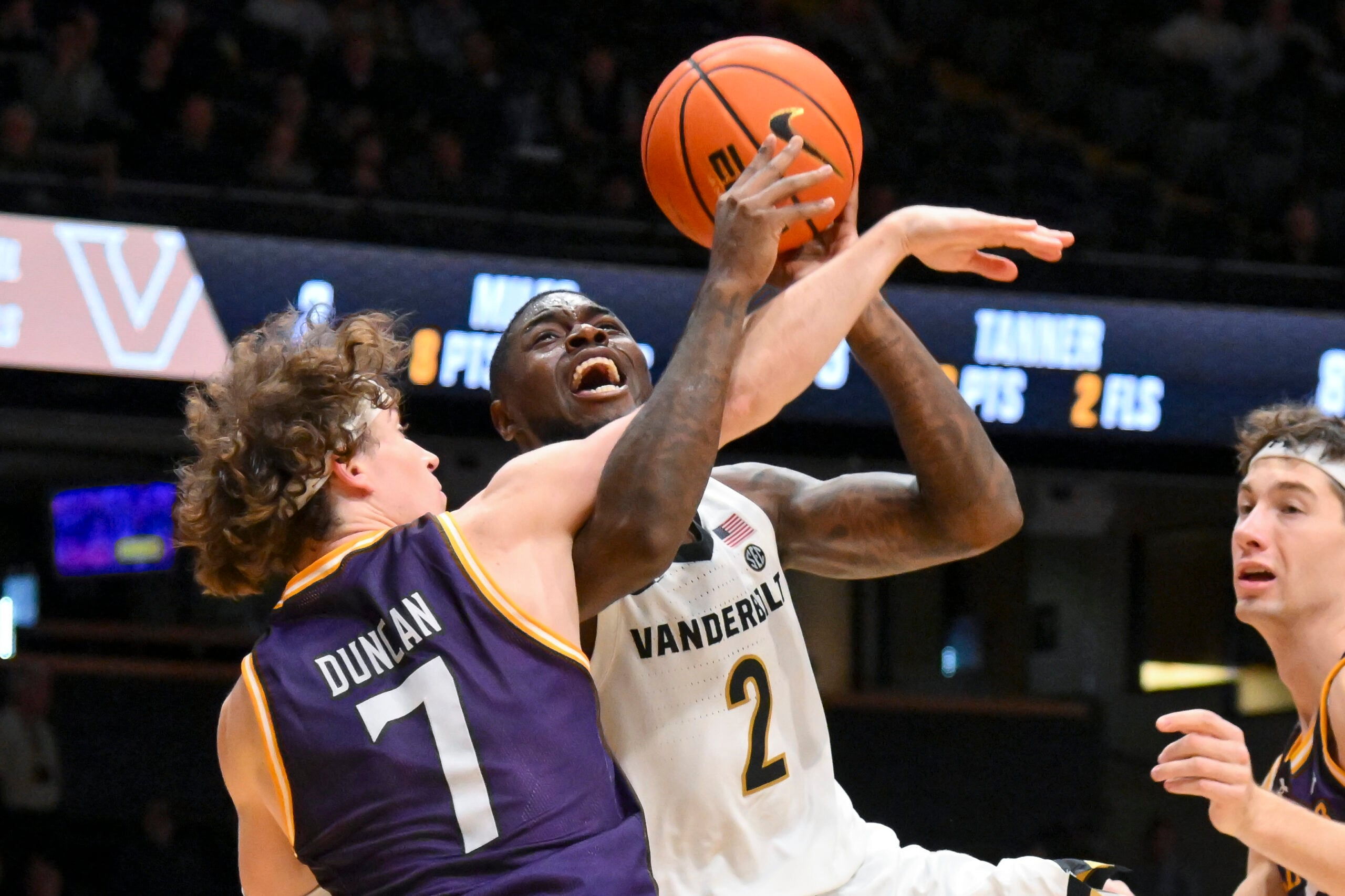 Nov 3, 2025; Nashville, Tennessee, USA;  Lipscomb Bisons guard Ethan Duncan (7) fouls Vanderbilt Commodores guard Duke Miles (2) during the second half at Memorial Gymnasium. Mandatory Credit: Steve Roberts-Imagn Images