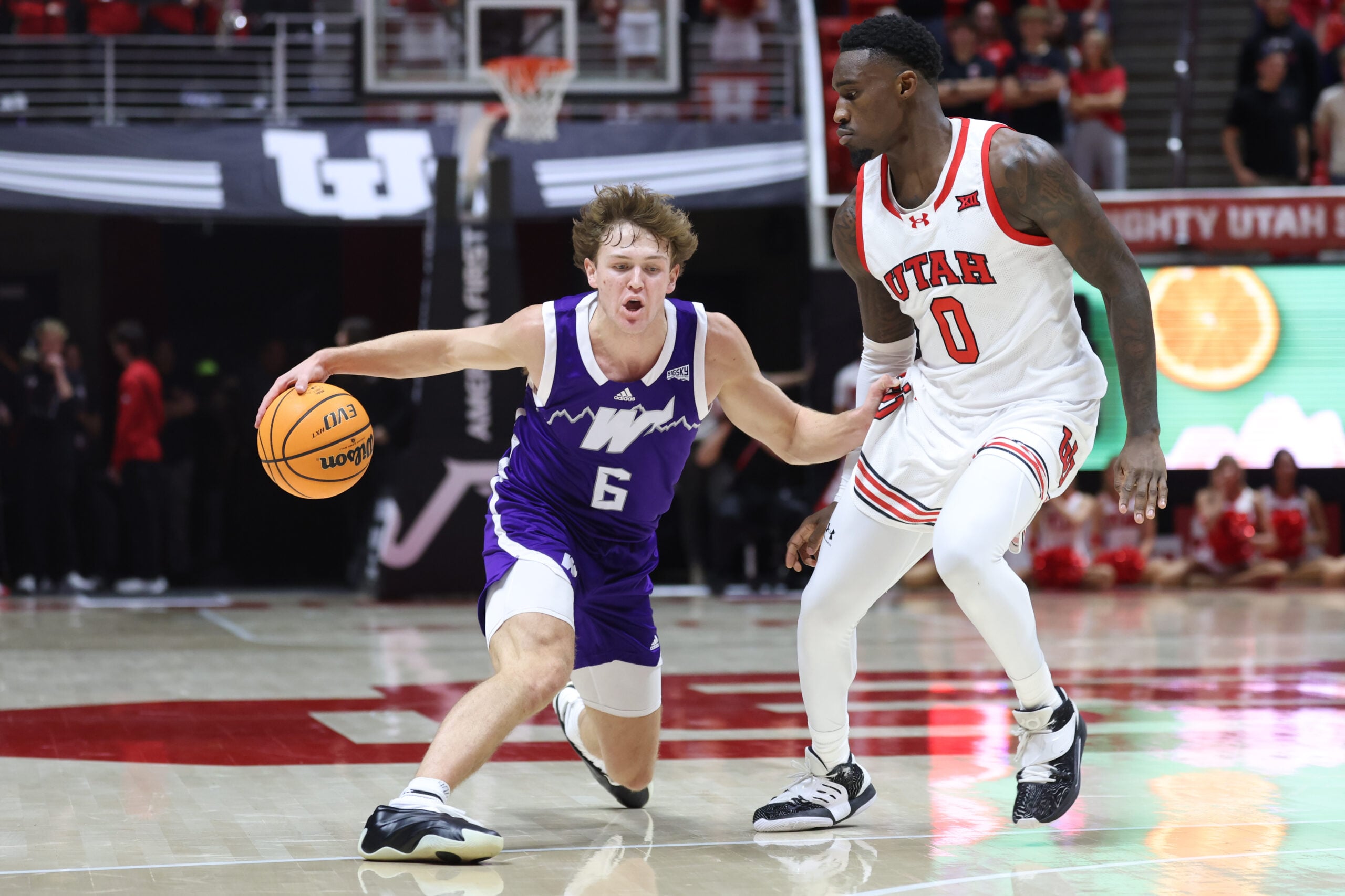 Nov 8, 2025; Salt Lake City, Utah, USA; Weber State Wildcats guard Trevor Hennig (6) dribbles against Utah Utes forward Seydou Traore (0) during the first half at Jon M. Huntsman Center. Mandatory Credit: Rob Gray-Imagn Images