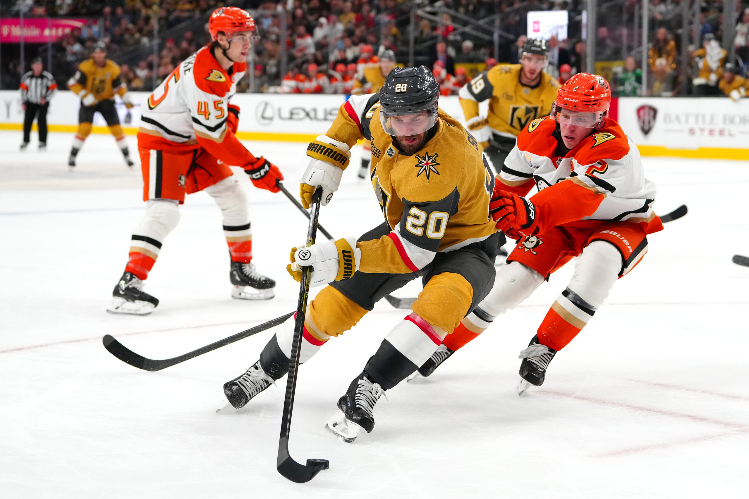 Nov 8, 2025; Las Vegas, Nevada, USA; Vegas Golden Knights left wing Brandon Saad (20) controls the puck ahead of Anaheim Ducks defenseman Jackson Lacombe (2) during the second period at T-Mobile Arena. Mandatory Credit: Stephen R. Sylvanie-Imagn Images
