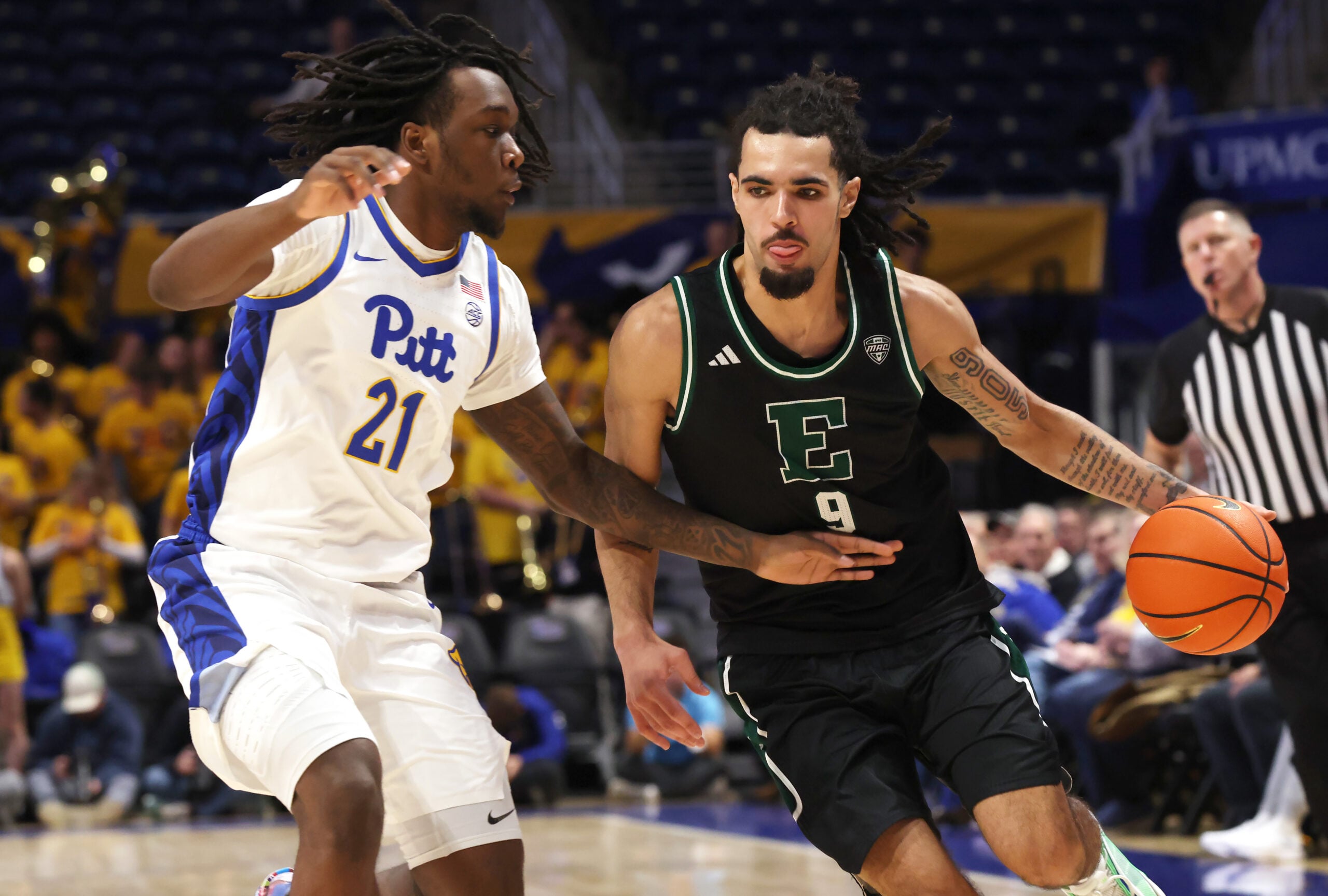 Nov 10, 2025; Pittsburgh, Pennsylvania, USA;  Eastern Michigan Eagles forward Addison Patterson (9) dribbles the ball as Pittsburgh Panthers guard Macari Moore (21) defends during the first half  at Petersen Events Center. Mandatory Credit: Charles LeClaire-Imagn Images