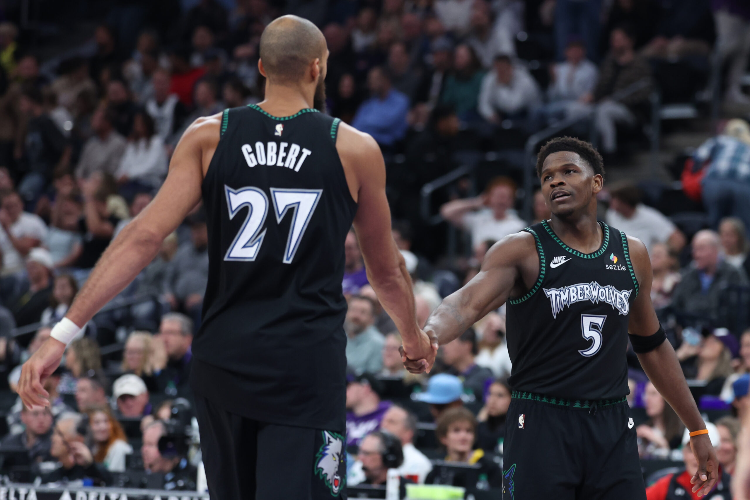 Nov 10, 2025; Salt Lake City, Utah, USA; Minnesota Timberwolves center Rudy Gobert (27) and guard Anthony Edwards (5) shake hands after a play against the Utah Jazz during the second half at Delta Center. Mandatory Credit: Rob Gray-Imagn Images