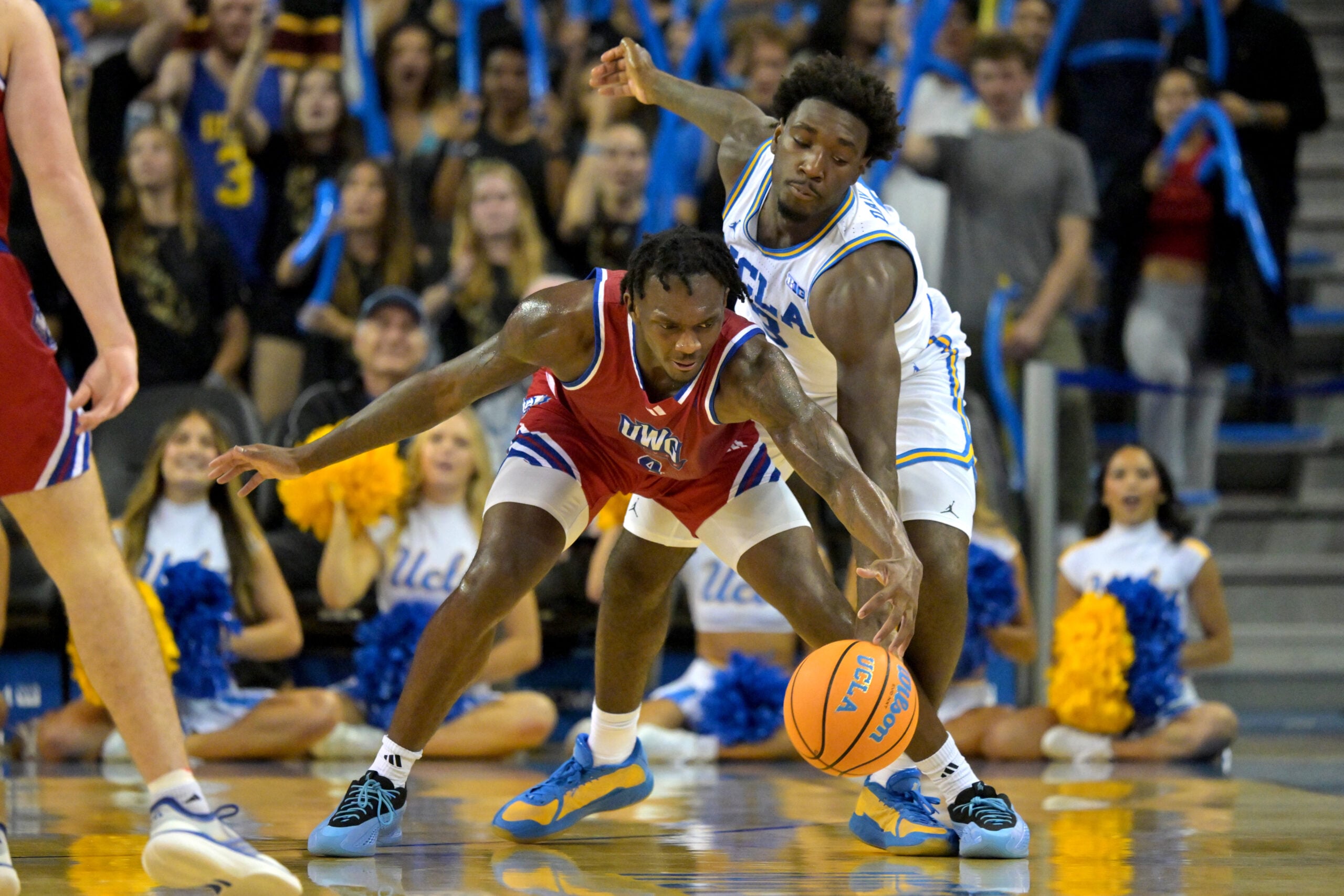 Nov 10, 2025; Los Angeles, California, USA;  West Georgia Wolves forward Shelton Williams-Dryden (4) keeps the ball from UCLA Bruins forward Eric Dailey Jr. (3) during the second half at Pauley Pavilion presented by Wescom Financial. Mandatory Credit: Jayne Kamin-Oncea-Imagn Images