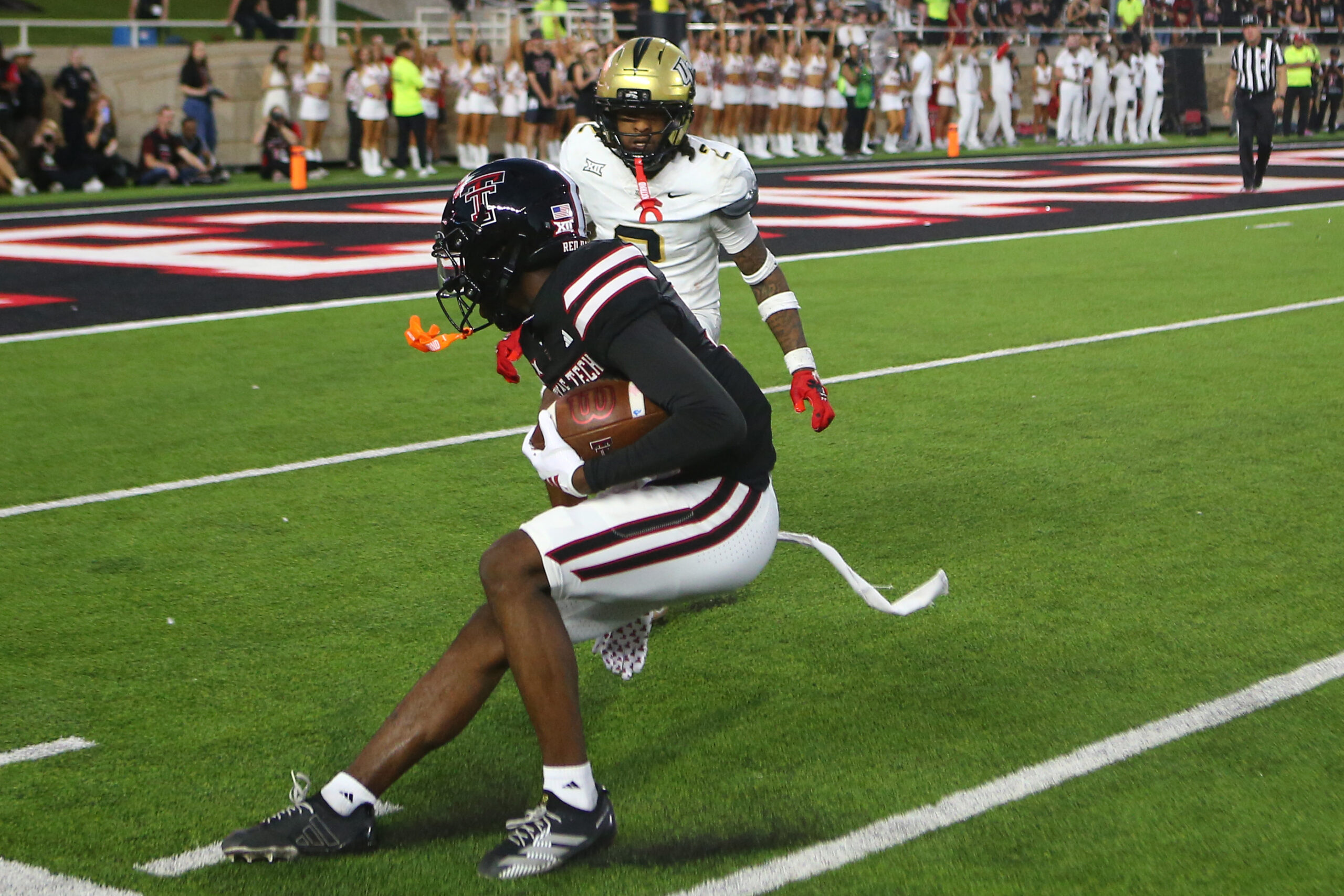 Nov 15, 2025; Lubbock, Texas, USA; Texas Tech Red Raiders wide receiver Tristian Gentry (21) makes a catch against Central Florida Knights defensive safety Phillip Dunnam (2) in the second half at Jones AT&T Stadium. Mandatory Credit: Michael C. Johnson-Imagn Images