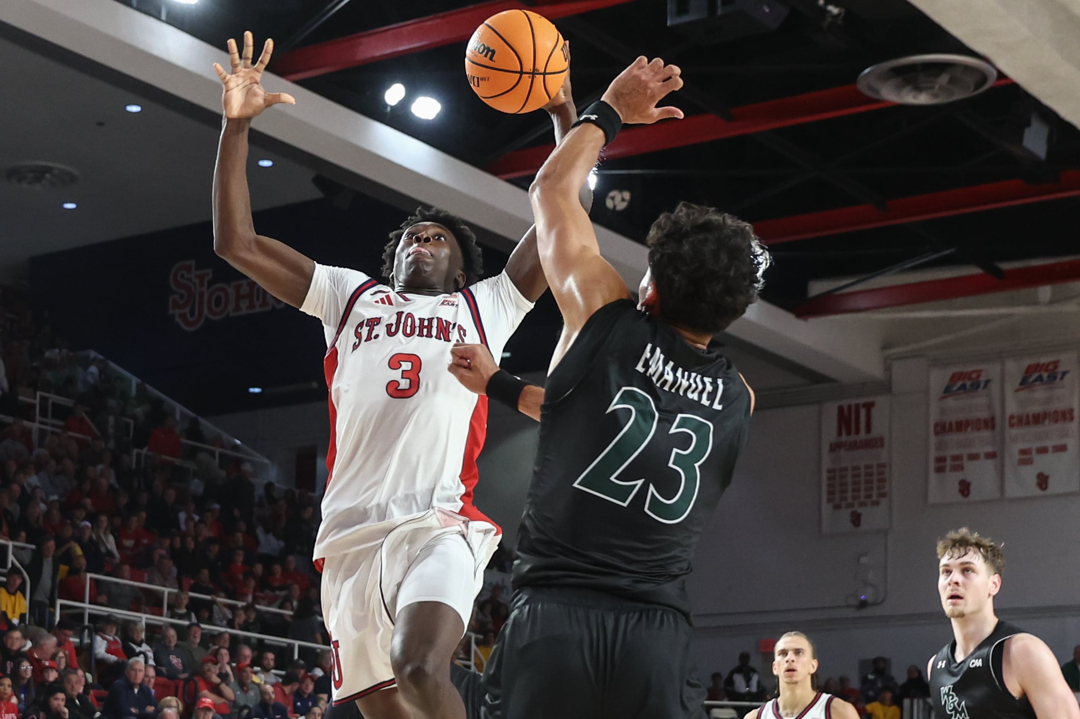 Nov 15, 2025; Queens, New York, USA;  St. John's Red Storm guard Joson Sanon (3) looks to drive past William & Mary Tribe forward Jo'El Emanuel (23) in the second half at Carnesecca Arena. Mandatory Credit: Wendell Cruz-Imagn Images