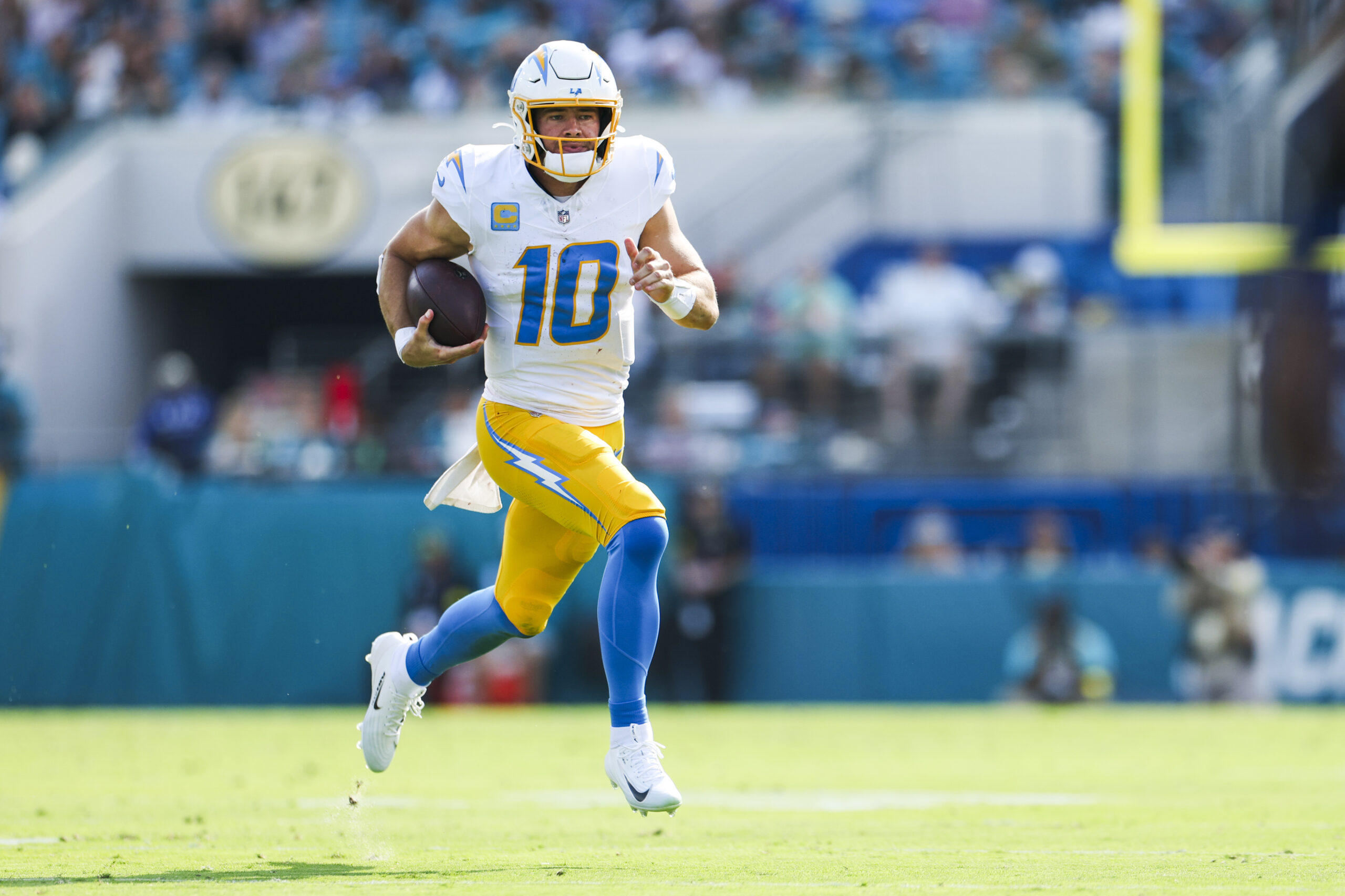 Nov 16, 2025; Jacksonville, Florida, USA; Los Angeles Chargers quarterback Justin Herbert (10) rushes against the Jacksonville Jaguars during the second quarter at EverBank Stadium. Mandatory Credit: Nathan Ray Seebeck-Imagn Images