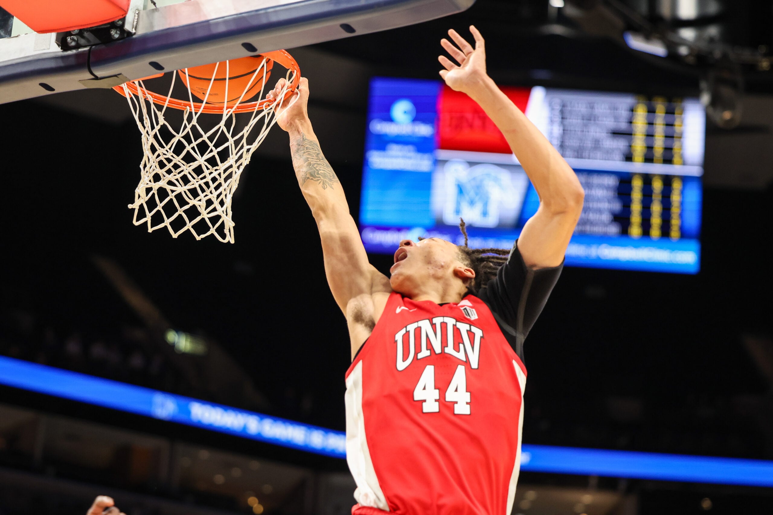 Nov 16, 2025; Memphis, Tennessee, USA; UNLV Rebels forward Tyron Jones (44) dunks the ball against the Memphis Tigers during the second half at FedExForum. Mandatory Credit: Wesley Hale-Imagn Images