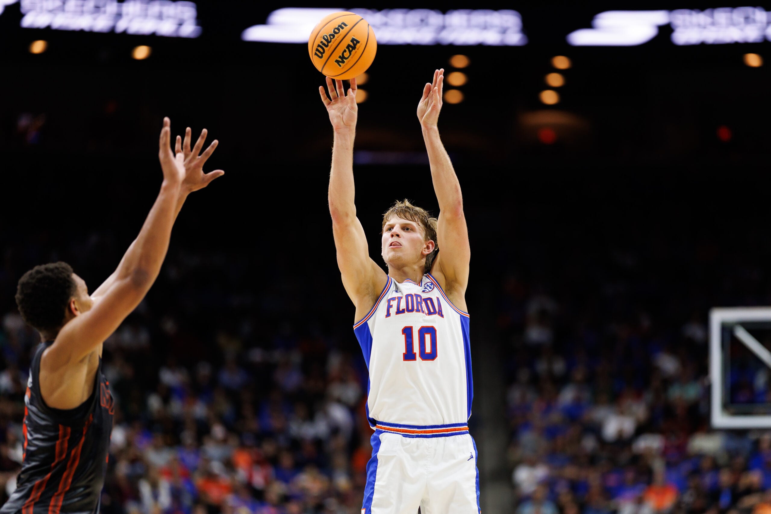 Nov 16, 2025; Jacksonville, Florida, USA; Florida Gators forward Thomas Haugh (10) makes a three point basket over Miami Hurricanes forward Malik Reneau (5) to end the first half at VyStar Veterans Memorial Arena. Mandatory Credit: Matt Pendleton-Imagn Images