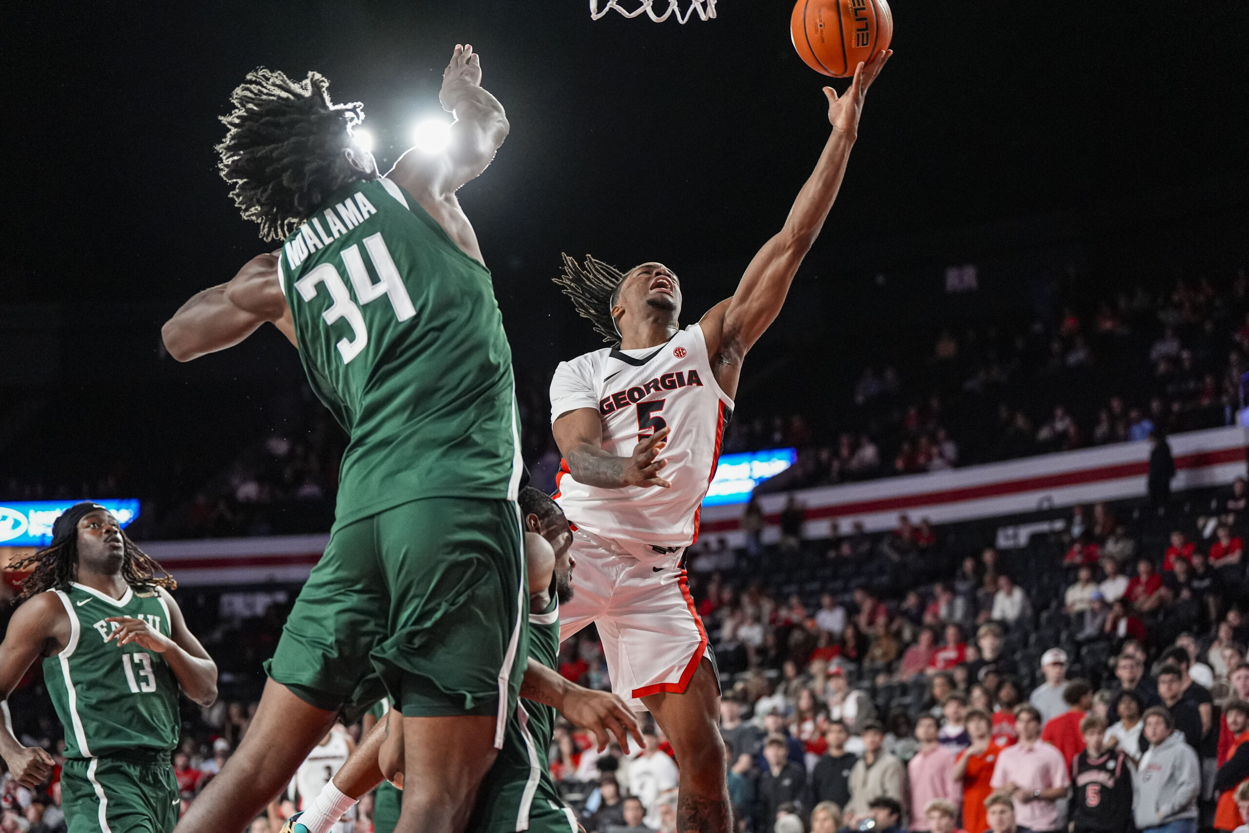 Nov 17, 2025; Athens, Georgia, USA; Georgia Bulldogs guard Jeremiah Wilkinson (5) shoots over Florida A&M Rattlers center Miles Ndalama (34) at Stegeman Coliseum. Mandatory Credit: Dale Zanine-Imagn Images