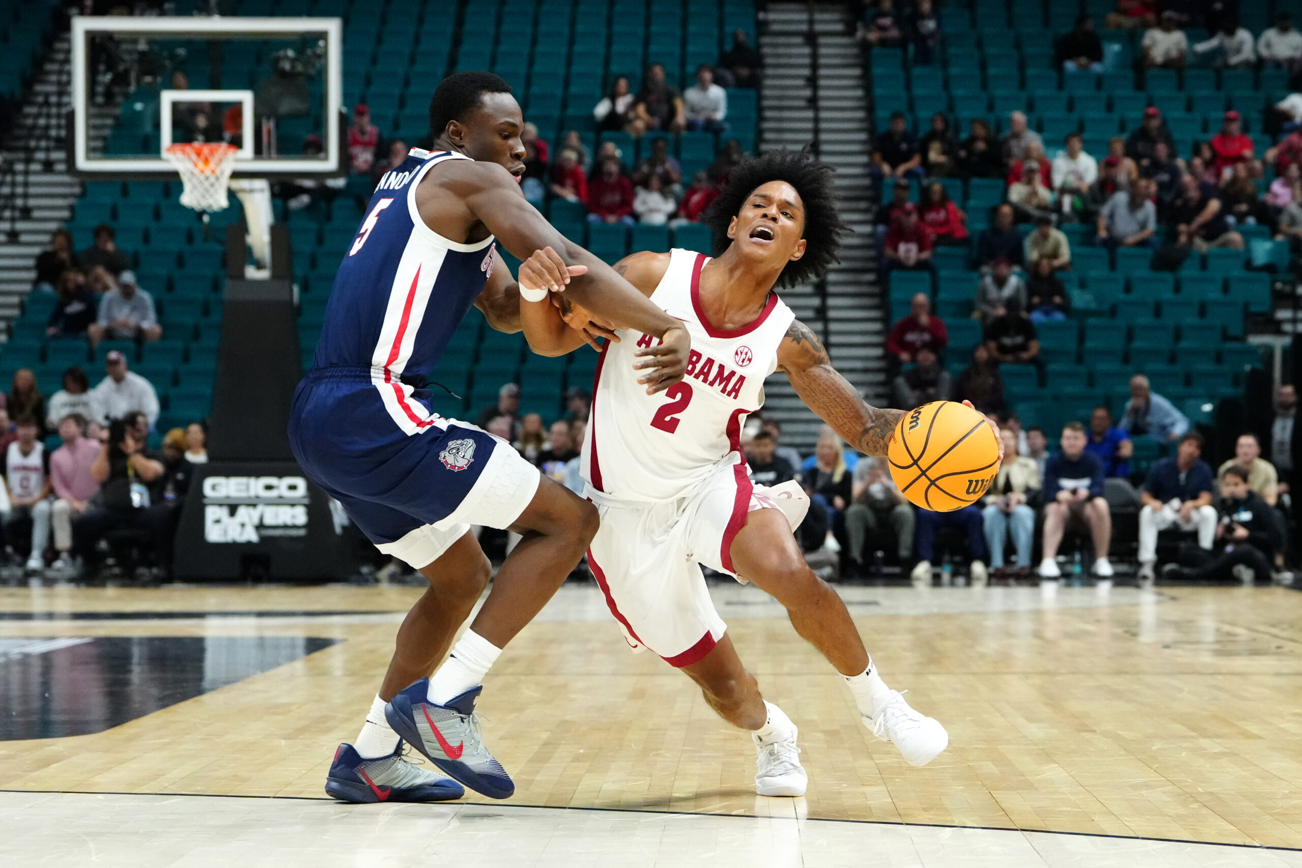 Nov 24, 2025; Las Vegas, Nevada, USA; Alabama Crimson Tide guard Aden Holloway (2) controls the ball against Gonzaga Bulldogs forward Emmanuel Innocenti (5) during the first half in a 2025 Players Era Festival group play game at MGM Grand Garden Arena. Mandatory Credit: Stephen R. Sylvanie-Imagn Images