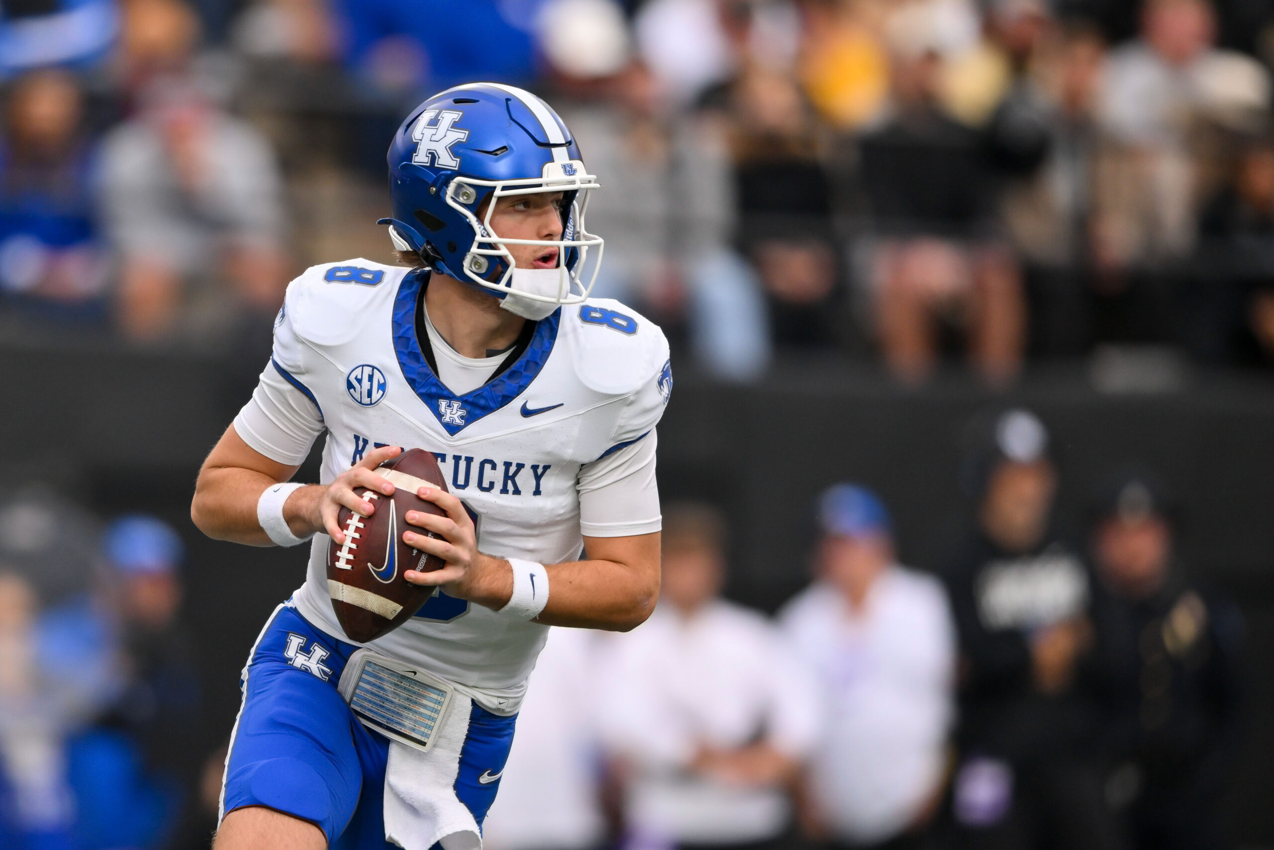 Nov 22, 2025; Nashville, Tennessee, USA;  Kentucky Wildcats quarterback Cutter Boley (8) scrambles against the Vanderbilt Commodores during the first half at FirstBank Stadium. Mandatory Credit: Steve Roberts-Imagn Images