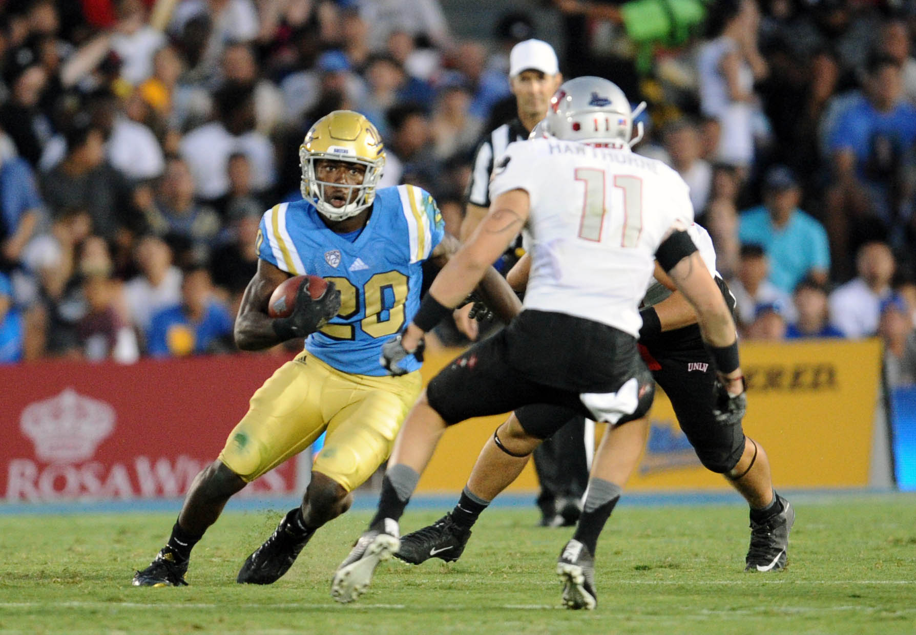 September 10, 2016; Pasadena, CA, USA;  UCLA Bruins running back Brandon Stephens (20) runs the ball against the UNLV Rebels during the second half at Rose Bowl. Mandatory Credit: Gary A. Vasquez-Imagn Images