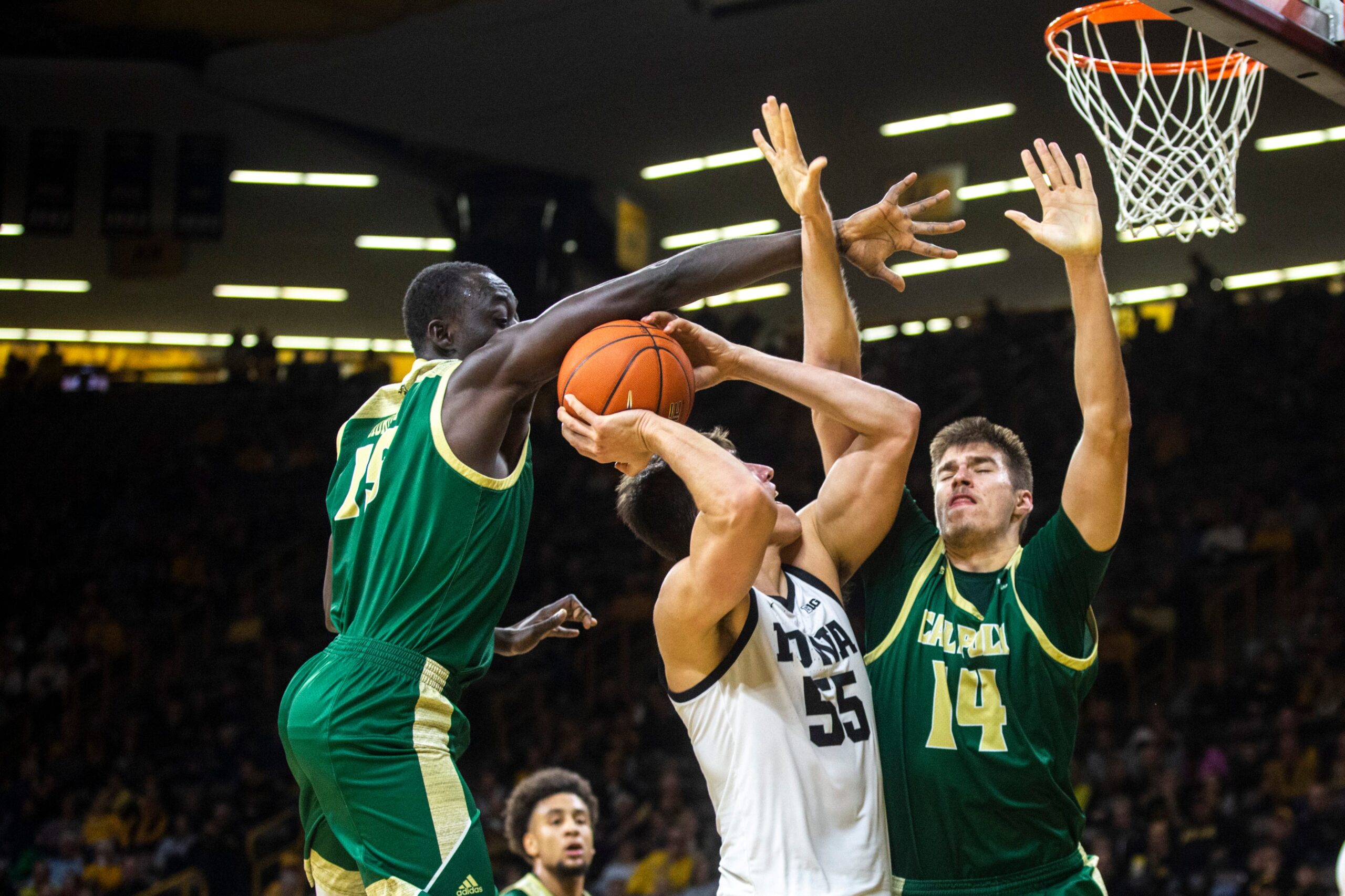 Iowa center Luka Garza (55) gets fouled by Cal Poly's Alimamy Koroma, left, as Tuukka Jaakkola (14) defends during a NCAA non-conference men's basketball game, Sunday, Nov. 24, 2019, at Carver-Hawkeye Arena in Iowa City, Iowa.

191123 Cal Poly Iowa Mbb 028 Jpg