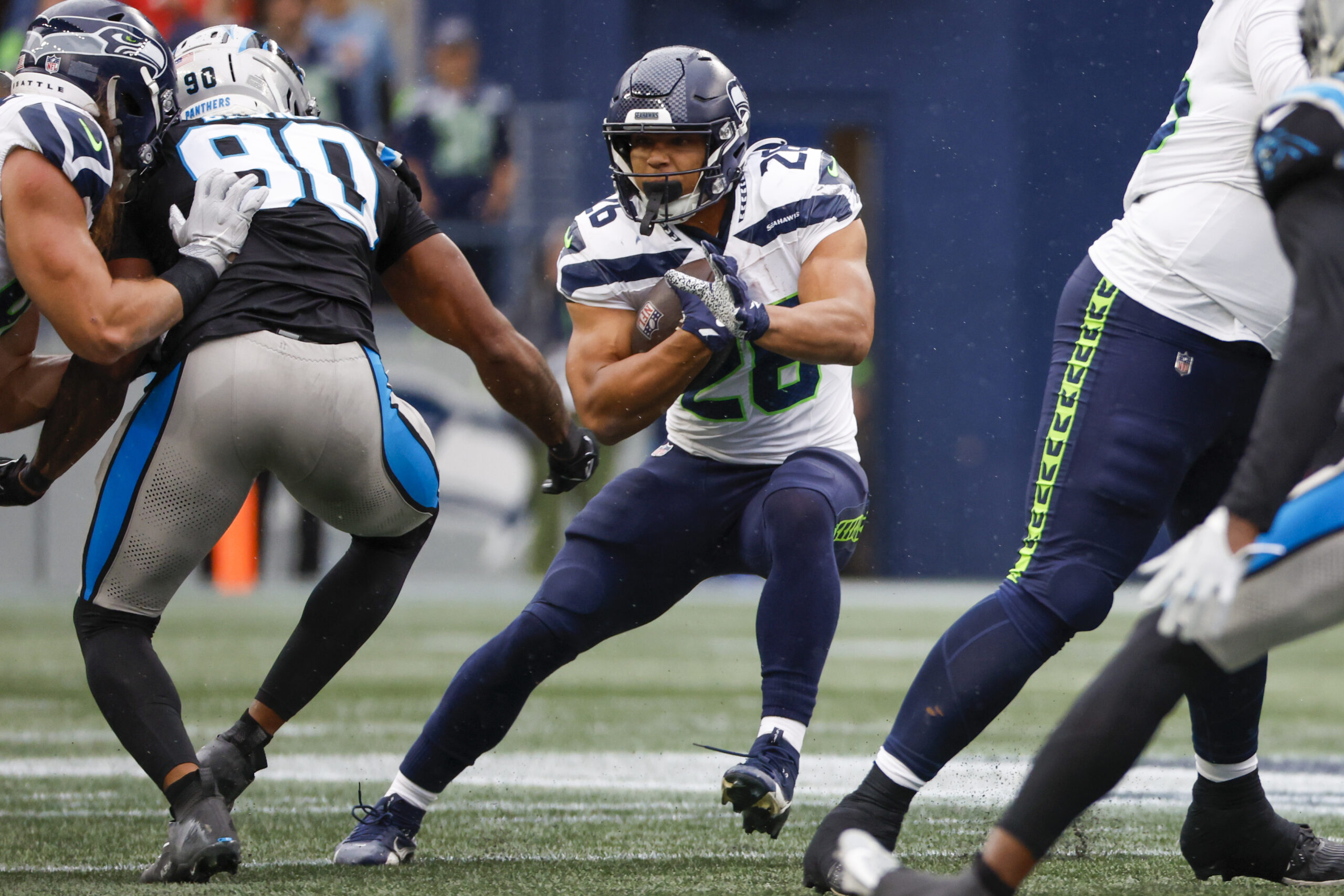 Sep 24, 2023; Seattle, Washington, USA; Seattle Seahawks running back Zach Charbonnet (26) rushes against the Carolina Panthers during the fourth quarter at Lumen Field. Mandatory Credit: Joe Nicholson-Imagn Images