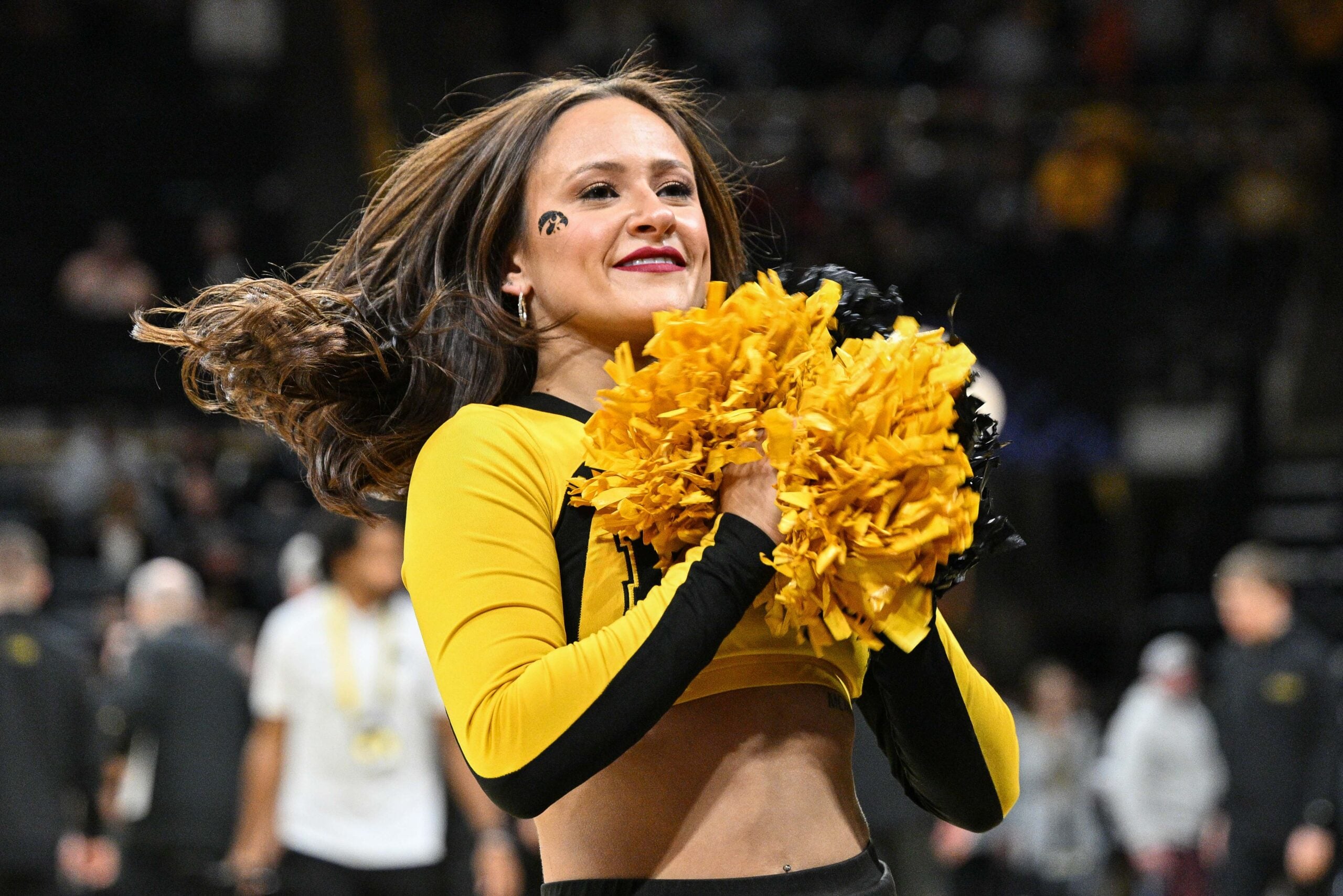 Dec 29, 2023; Iowa City, Iowa, USA; A Iowa Hawkeyes cheerleader looks on during the game against the Northern Illinois Huskies at Carver-Hawkeye Arena. Mandatory Credit: Jeffrey Becker-Imagn Images