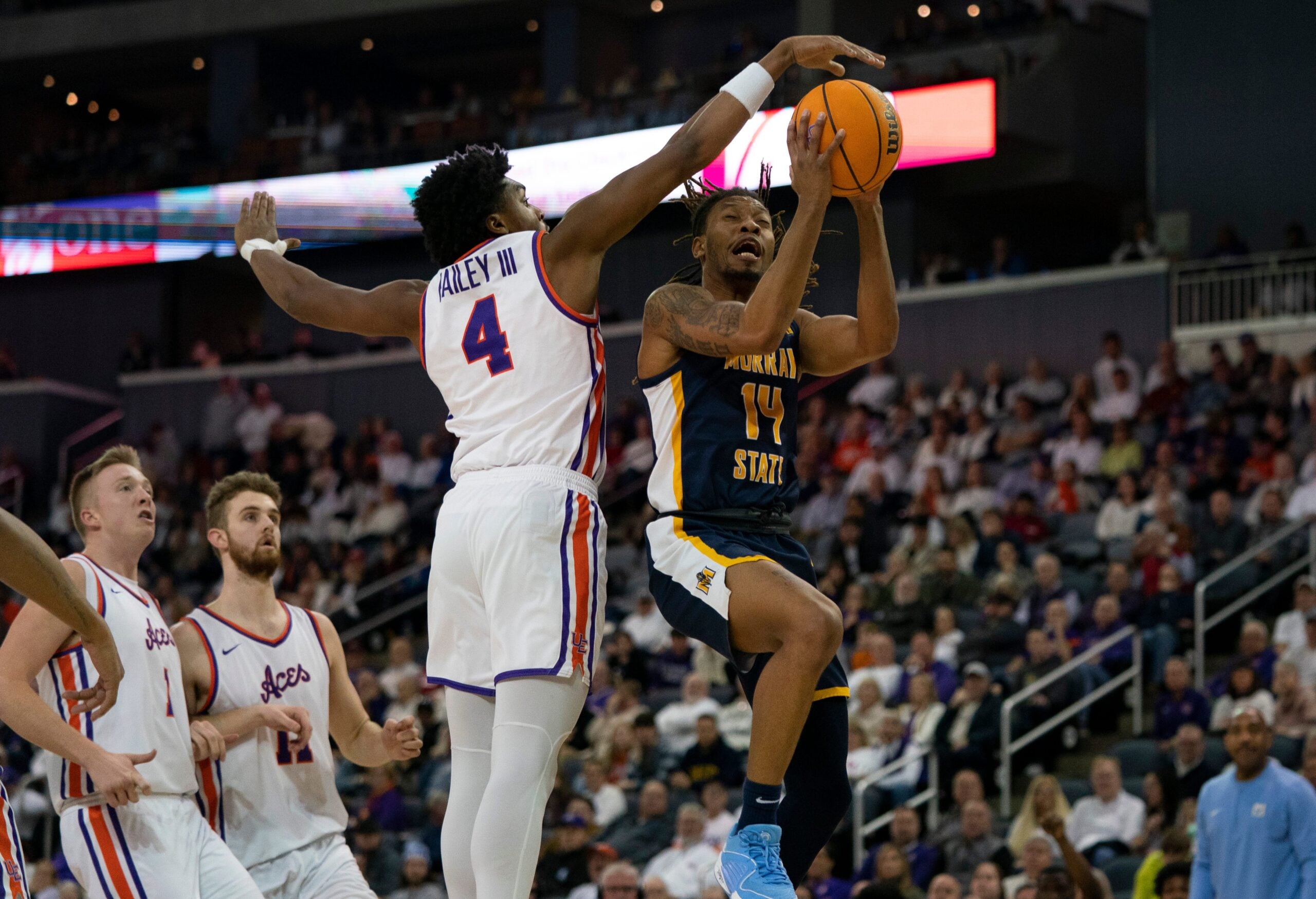 Murray State   s Brain Moore Jr. (14) goes up against Evansville   s Chuck Bailey III (4) as the University of Evansville Purple Aces play the Murray State Racers at Ford Center in Evansville, Ind., Saturday, Jan. 6, 2024. Murray State beat Evansville 81-59.