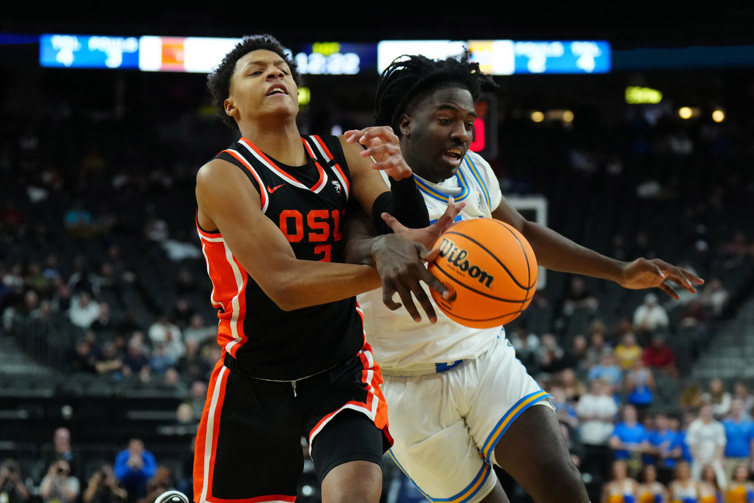 Mar 13, 2024; Las Vegas, NV, USA; Oregon State Beavers guard Josiah Lake II (2) and UCLA Bruins guard Will McClendon (4) battle for the ball in the first half  at T-Mobile Arena. Mandatory Credit: Kirby Lee-Imagn Images