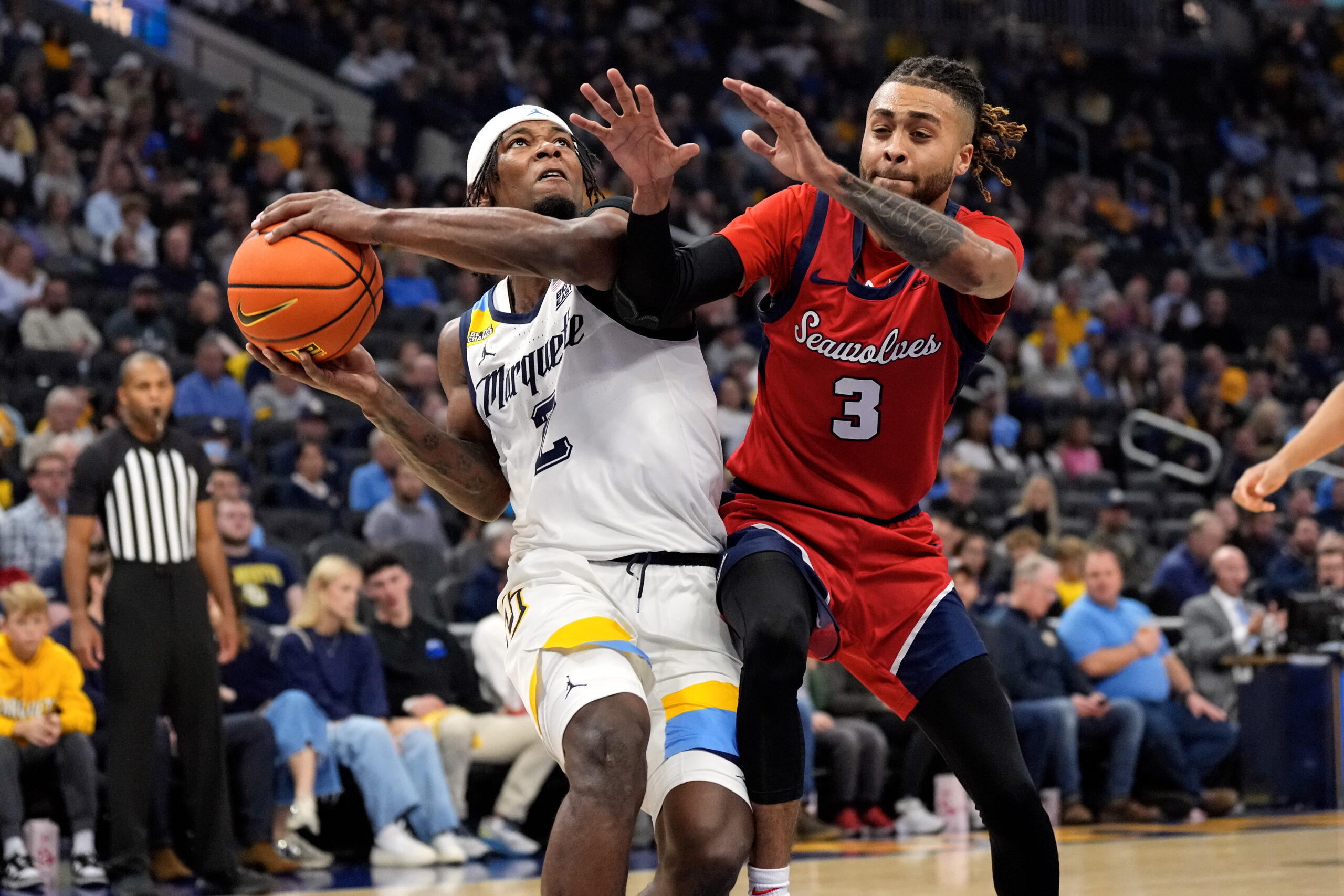 Nov 4, 2024; Milwaukee, Wisconsin, USA;  Marquette Golden Eagles guard Chase Ross (2) drives for the basket against Stony Brook Seawolves guard CJ Luster II (3) during the second half at Fiserv Forum. Mandatory Credit: Jeff Hanisch-Imagn Images