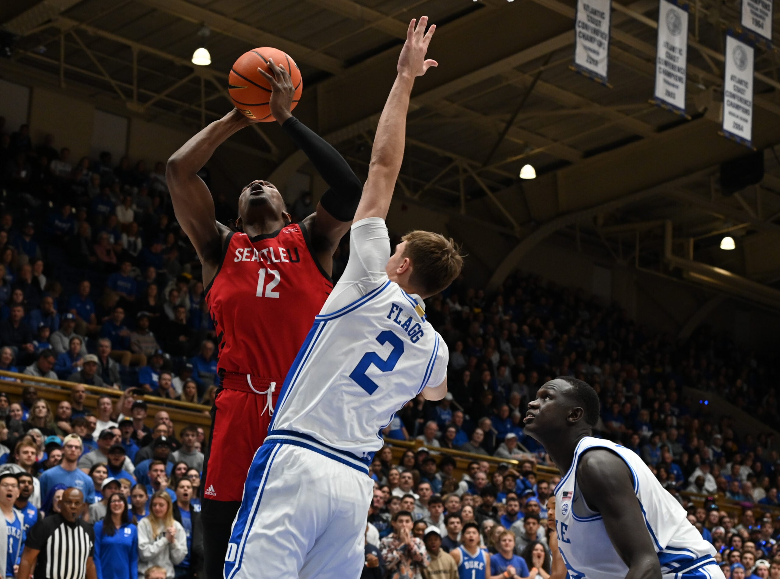 Nov 29, 2024; Durham, North Carolina, USA;Seattle Redhawks forward Matthew-Alexander Moncrieffe (12) shoots over Duke Blue Devils forward Cooper Flagg (2)during the first half at Cameron Indoor Stadium. Mandatory Credit: Rob Kinnan-Imagn Images