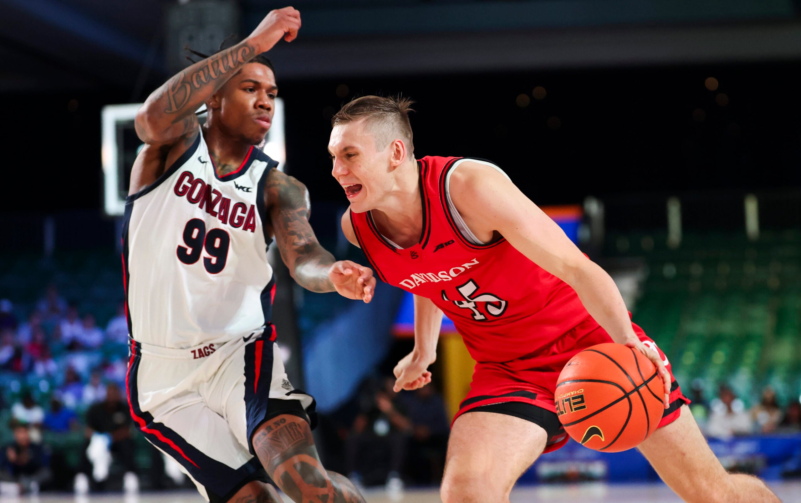 Nov 29, 2024; Paradise Island, Bahamas, BHS;  Davidson Wildcats guard Roberts Blums (45) drives to the basket as Gonzaga Bulldogs guard Khalif Battle (99) defends during the second half at Imperial Arena at the Atlantis resort.  Mandatory Credit: Kevin Jairaj-Imagn Images