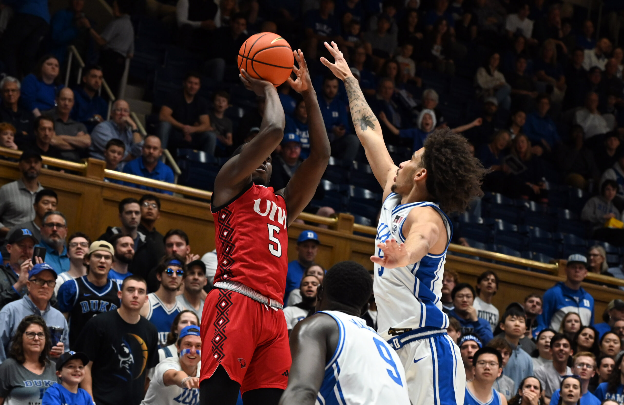 Dec 10, 2024; Durham, North Carolina, USA;  dIncarnate Word Cardinals guard Davion Bailey (5) shoots over Duke Blue Devils guard Tyrese Proctor (5) uring the first half at Cameron Indoor Stadium. Mandatory Credit: Rob Kinnan-Imagn Images