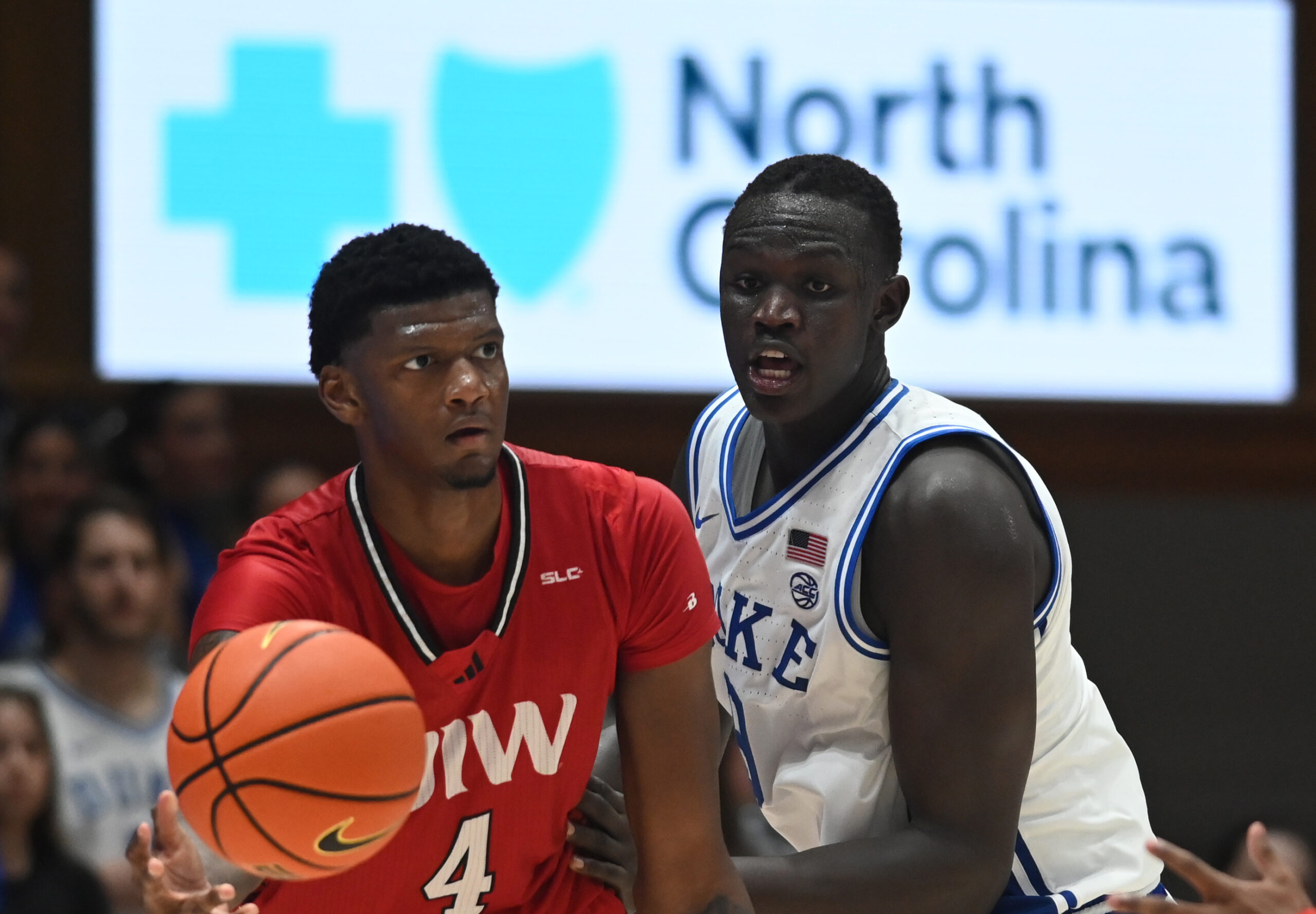 Dec 10, 2024; Durham, North Carolina, USA; Incarnate Word Cardinals forward Jayden Williams (4) looks to pass as Duke Blue Devils center Khaman Maluach (9) defends  during the second half at Cameron Indoor Stadium. Mandatory Credit: Rob Kinnan-Imagn Images