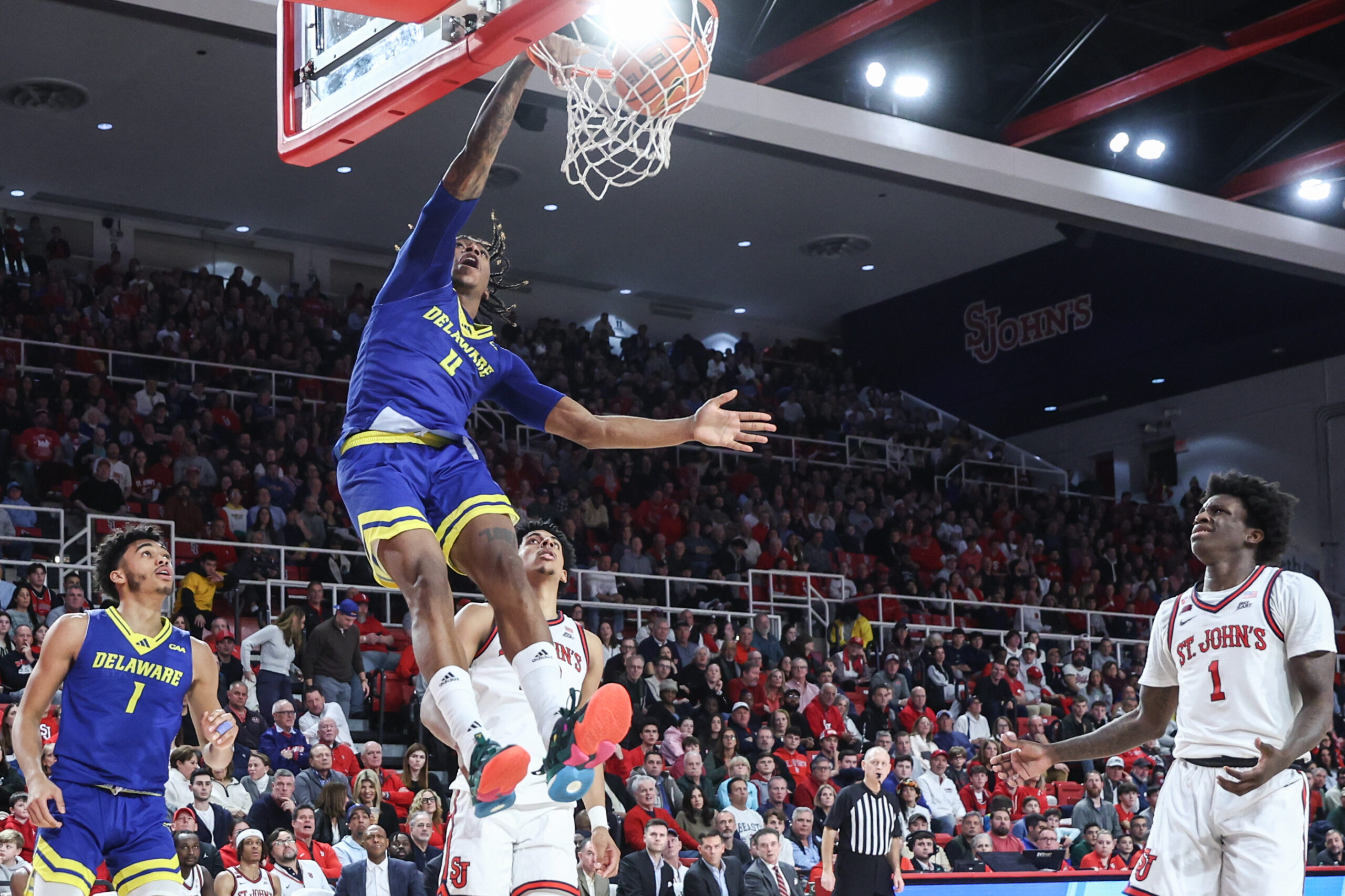 Dec 28, 2024; Queens, New York, USA;  Delaware Fightin Blue Hens guard Niels Lane (4) dunks in the first half against the St. John's Red Storm at Carnesecca Arena. Mandatory Credit: Wendell Cruz-Imagn Images