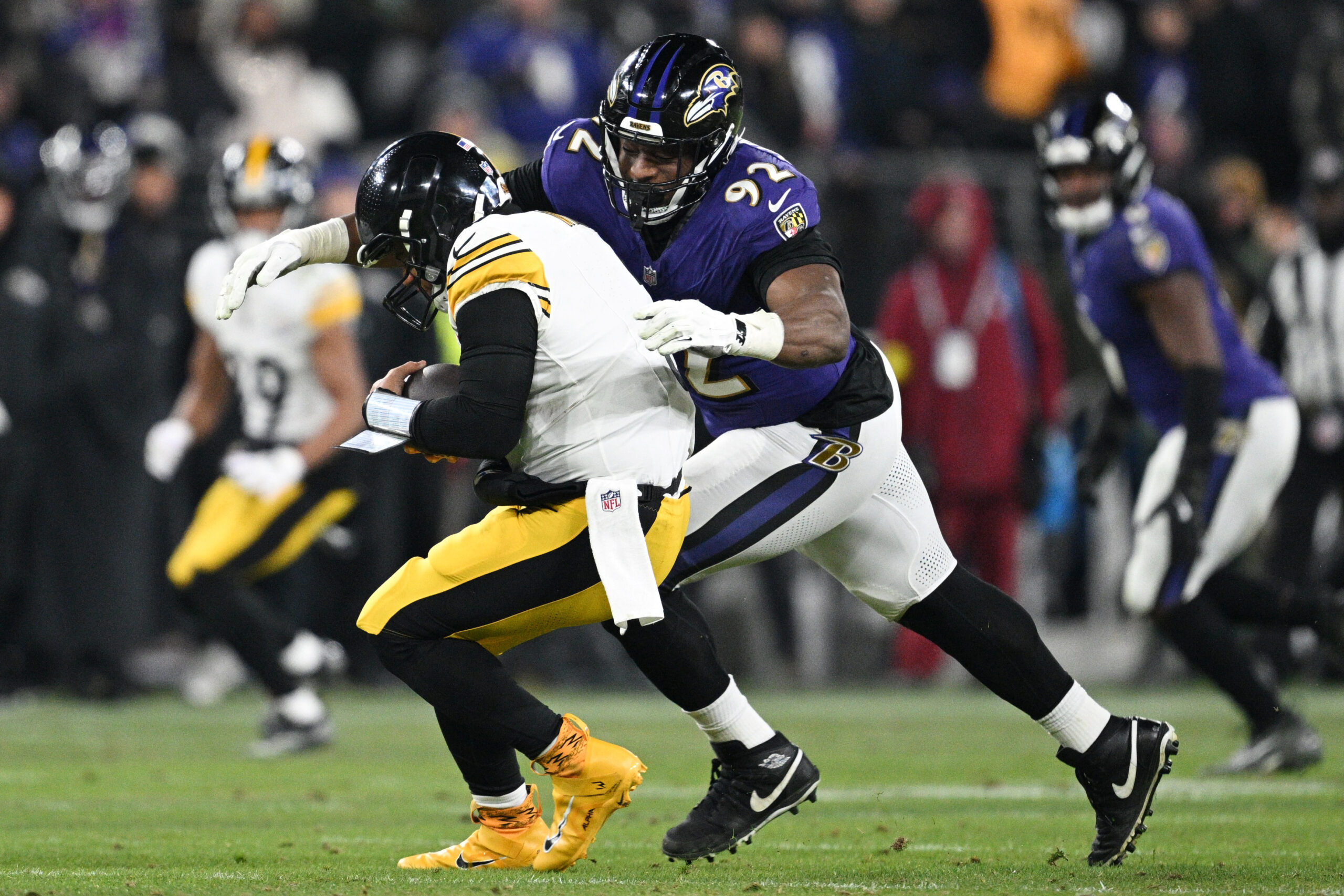Jan 11, 2025; Baltimore, Maryland, USA; Baltimore Ravens defensive tackle Nnamdi Madubuike (92) tackles Pittsburgh Steelers quarterback Russell Wilson (3) in the third quarter in an AFC wild card game at M&T Bank Stadium. Mandatory Credit: Tommy Gilligan-Imagn Images