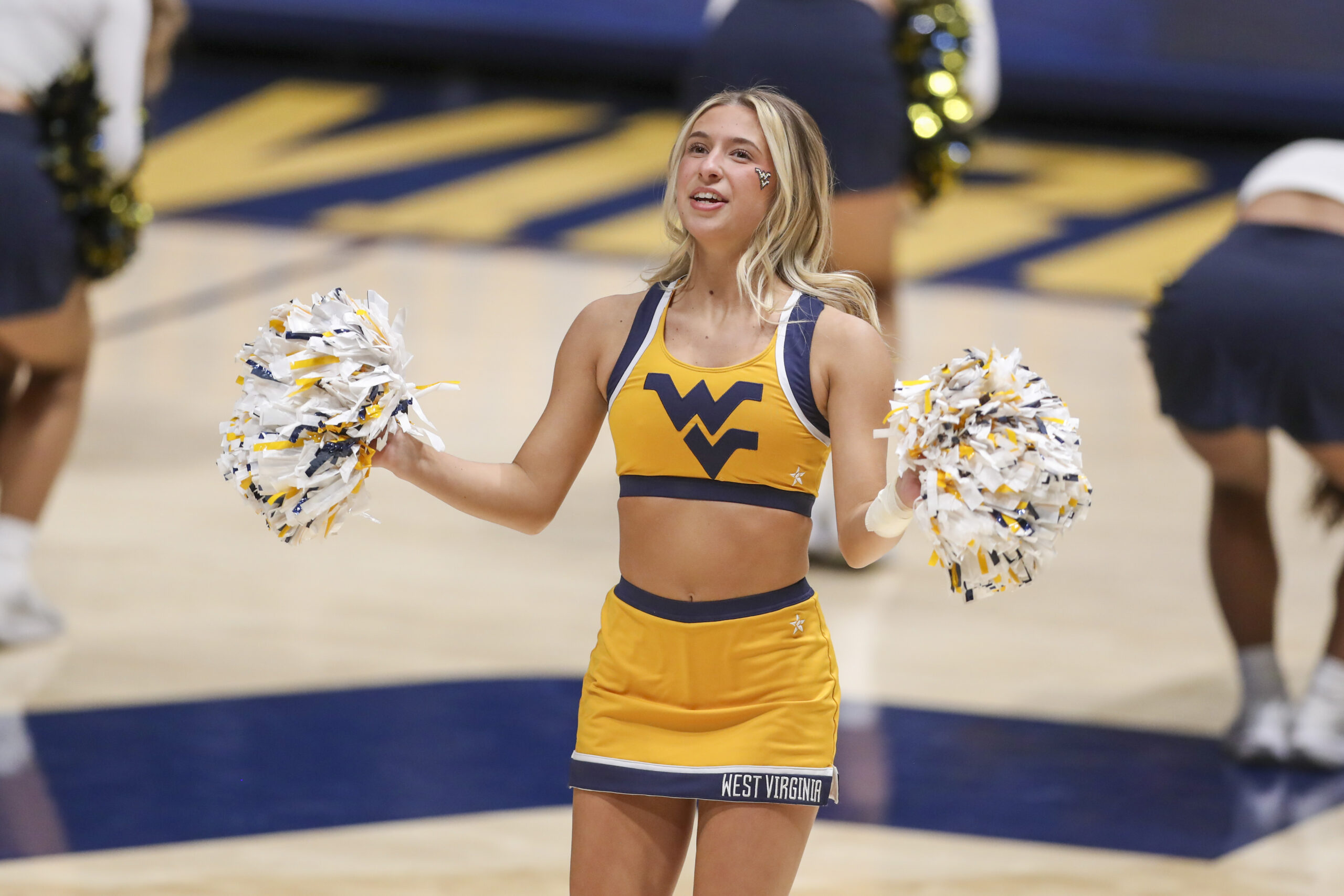 Jan 21, 2025; Morgantown, West Virginia, USA; A West Virginia Mountaineers cheerleader performs during the second half Arizona State Sun Devilsa at WVU Coliseum. Mandatory Credit: Ben Queen-Imagn Images
