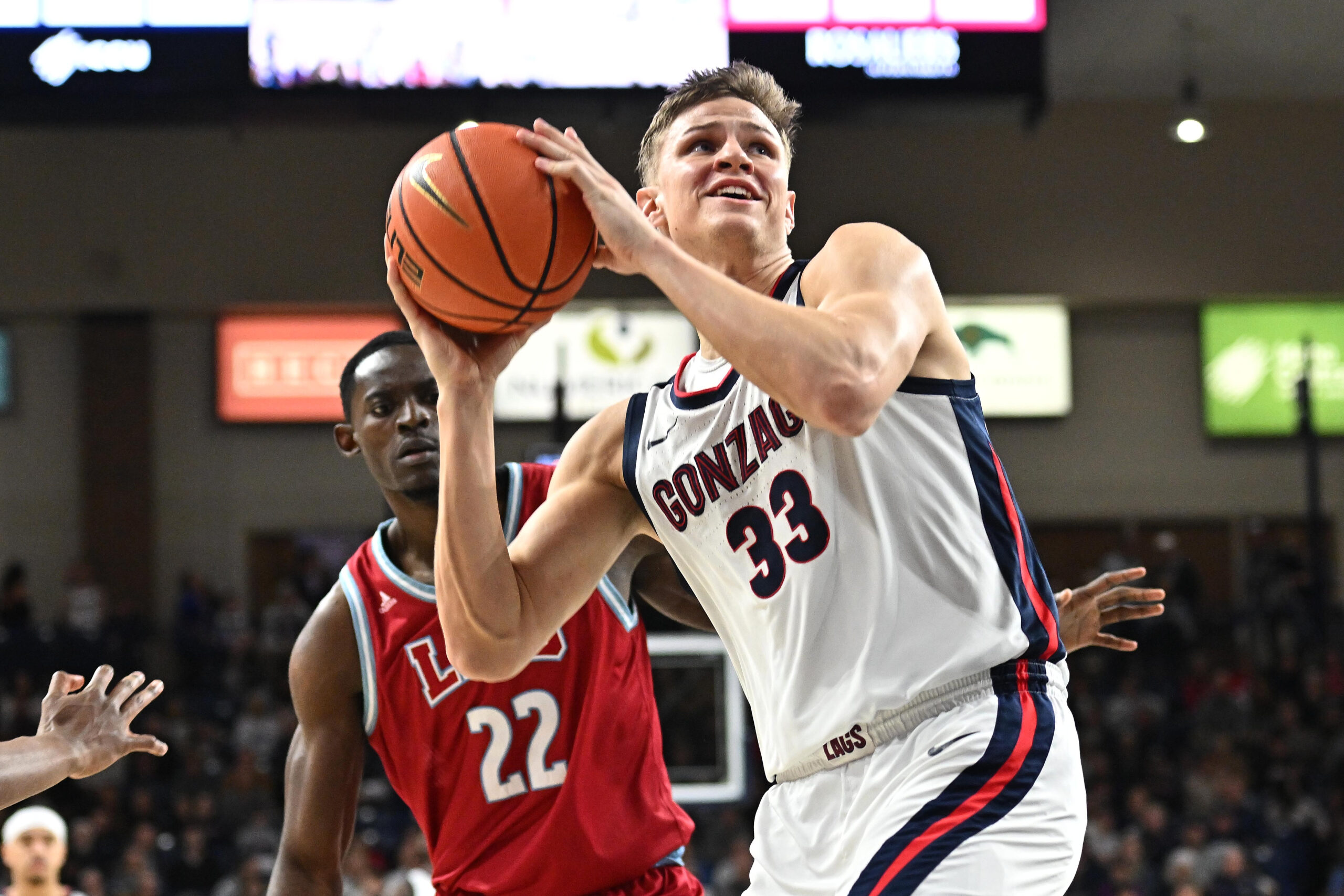 Feb 6, 2025; Spokane, Washington, USA; Gonzaga Bulldogs forward Ben Gregg (33) shoots against Loyola Marymount Lions center Rick Issanza (22) in the second half at McCarthey Athletic Center. Gonzaga Bulldogs won 73-53. Mandatory Credit: James Snook-Imagn Images