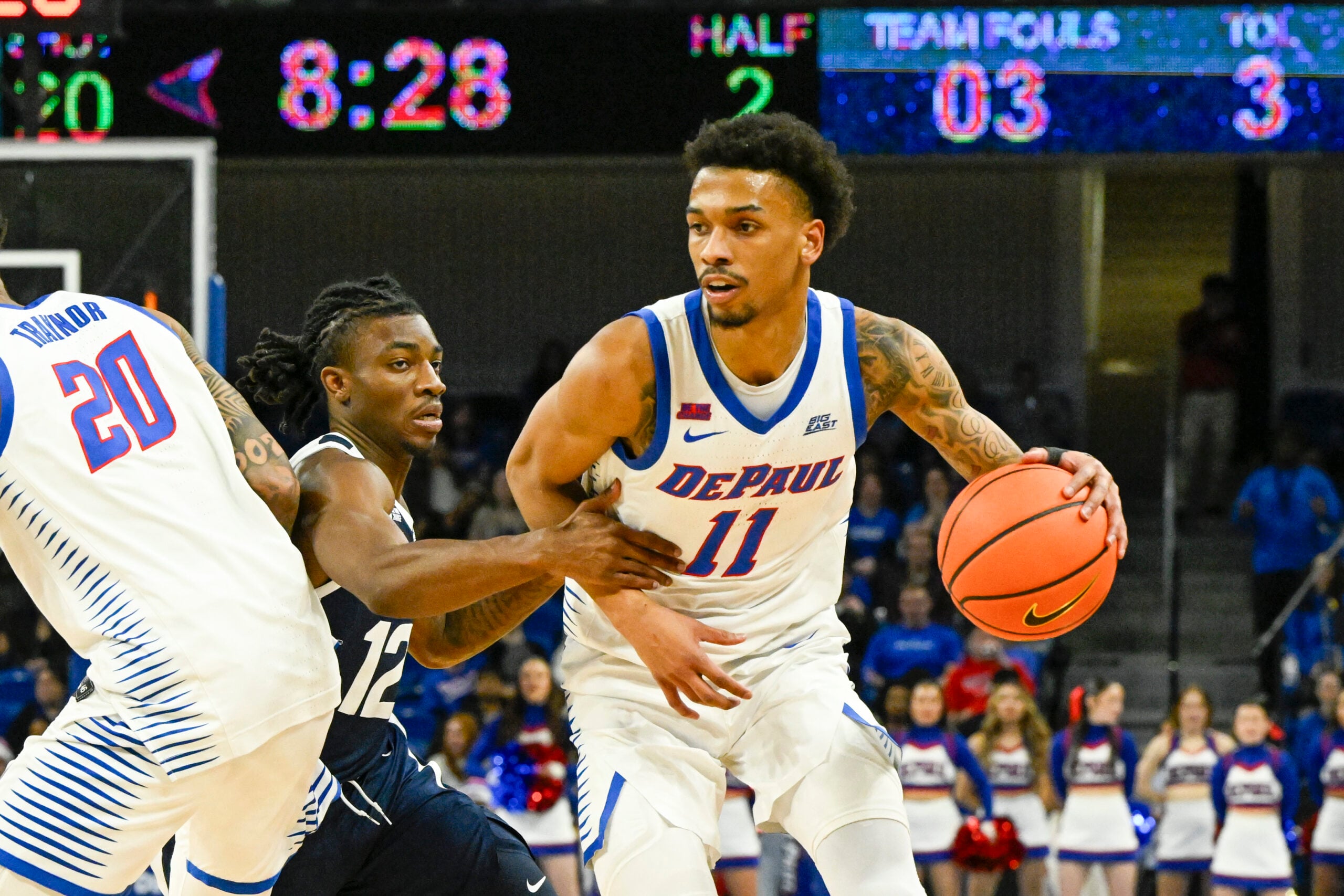 Feb 22, 2025; Chicago, Illinois, USA;  DePaul Blue Demons guard CJ Gunn (11) moves the ball against Butler Bulldogs guard Kolby King (12) during the second half at Wintrust Arena. Mandatory Credit: Matt Marton-Imagn Images