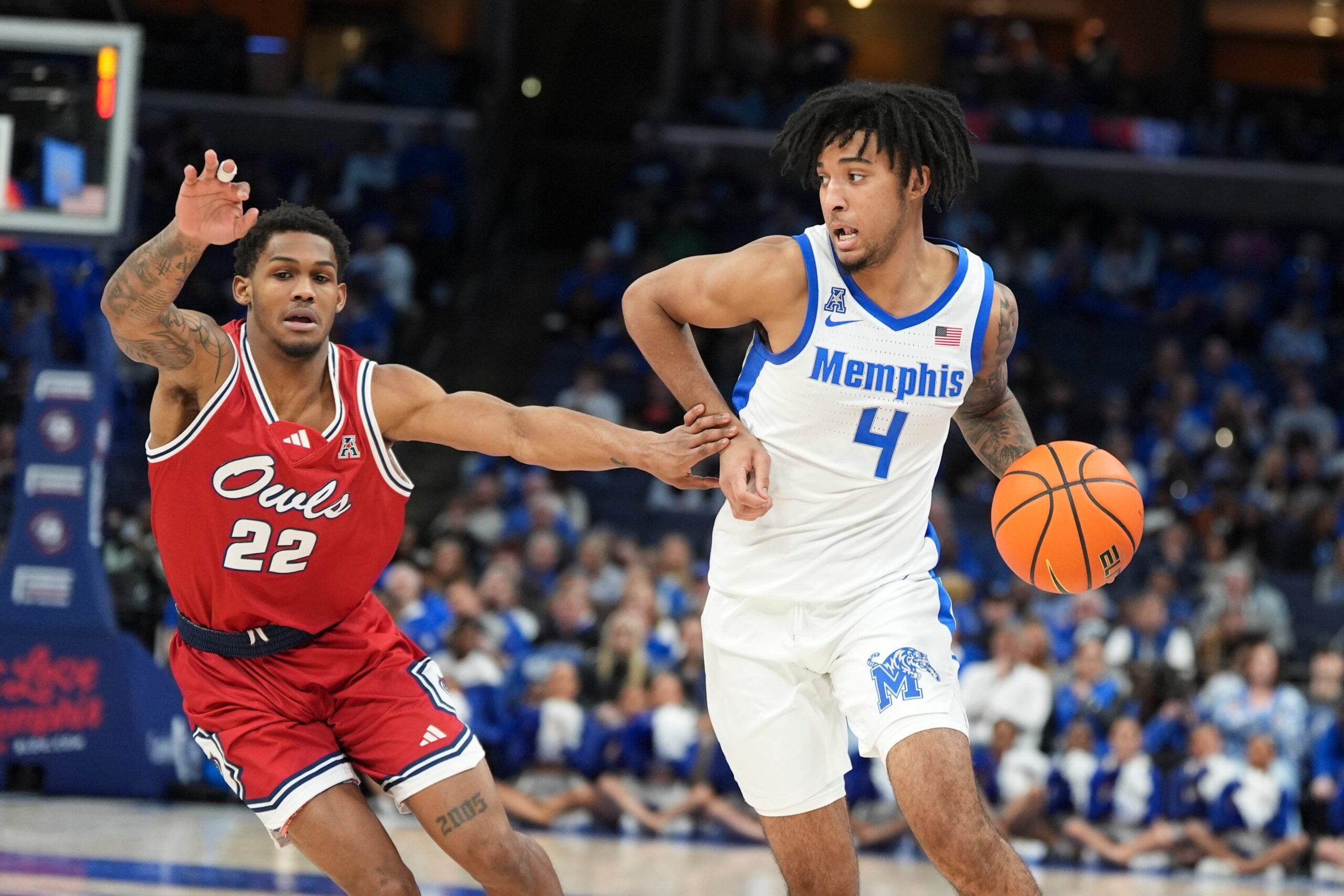 Memphis' PJ Haggerty (4) drives to the basket as FAU’s Devin Vanterpool (22) guards him during the game between Florida Atlantic University and the University of Memphis at FedExForum in Memphis, Tenn., on Sunday, February 23, 2025.