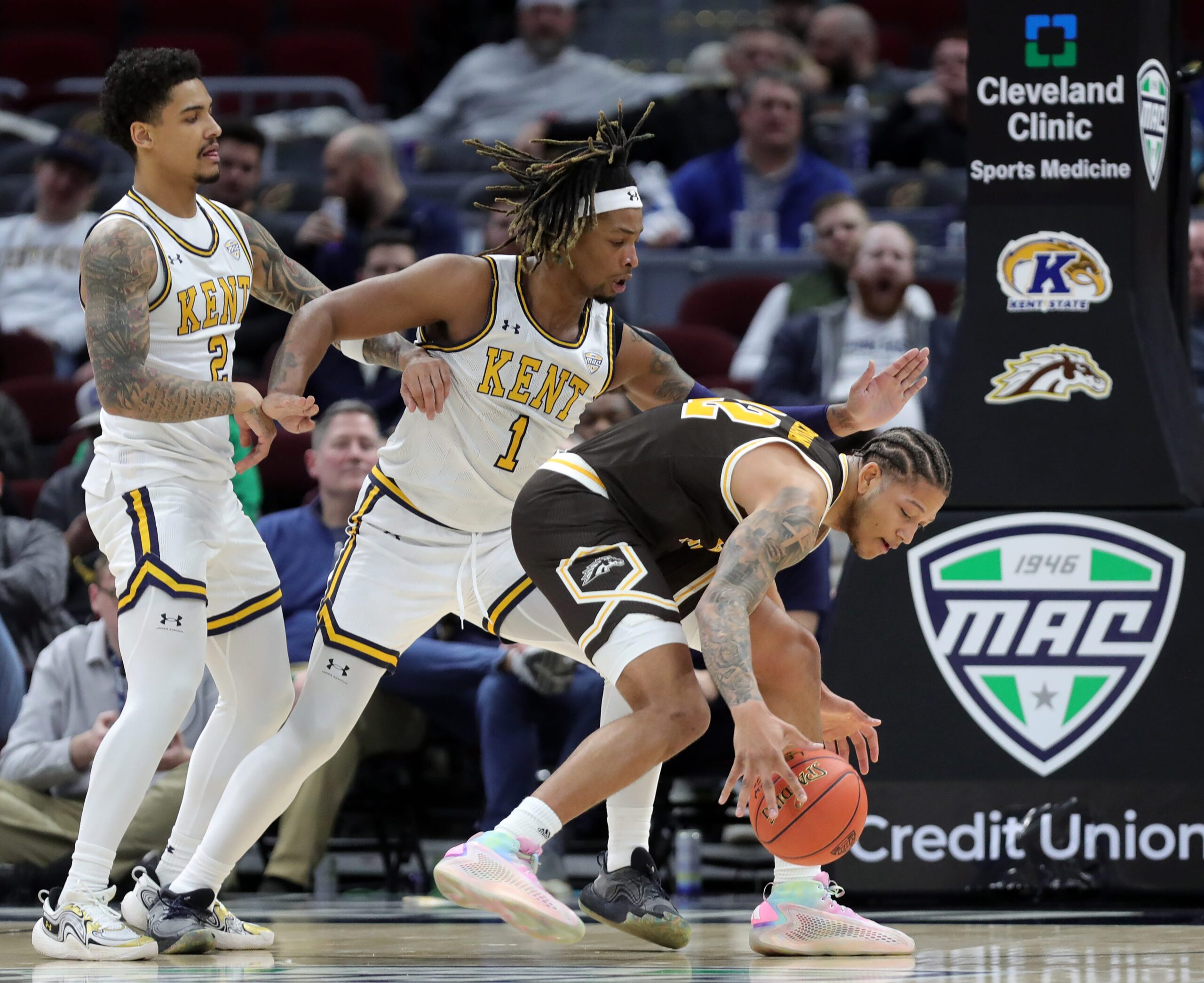 Kent State Golden Flashes guard Marquis Barnett (2) and forward VonCameron Davis (1) guard against Western Michigan Broncos guard Markhi Strickland (22) during the first half of an NCAA college basketball game in the quarterfinals of the Mid-American Conference Tournament at Rocket Arena on Thursday, March 13, 2025, in Cleveland, Ohio.
