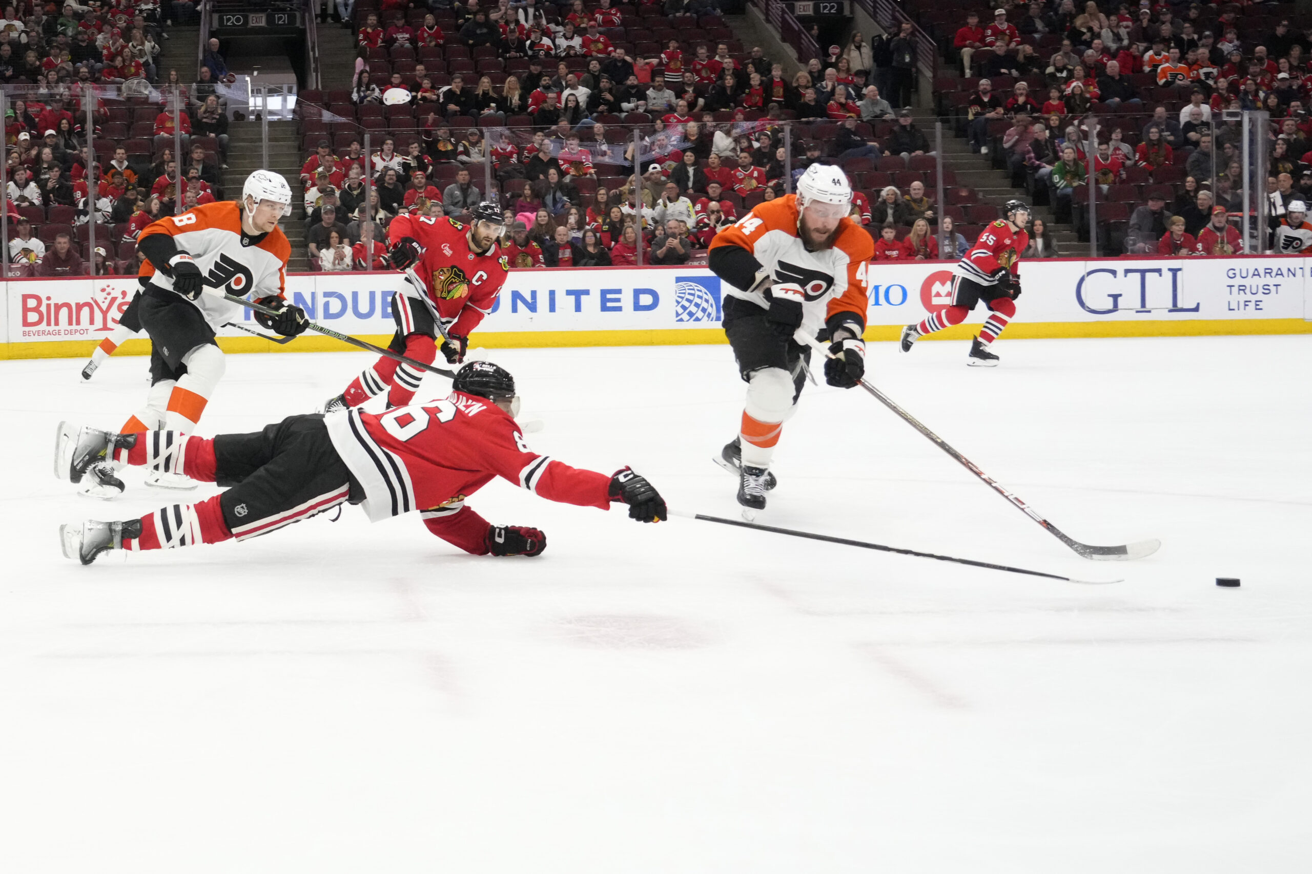 Mar 23, 2025; Chicago, Illinois, USA; Chicago Blackhawks center Teuvo Teravainen (86) and Philadelphia Flyers left wing Nicolas Deslauriers (44) go for the puck during the third period at United Center. Mandatory Credit: David Banks-Imagn Images