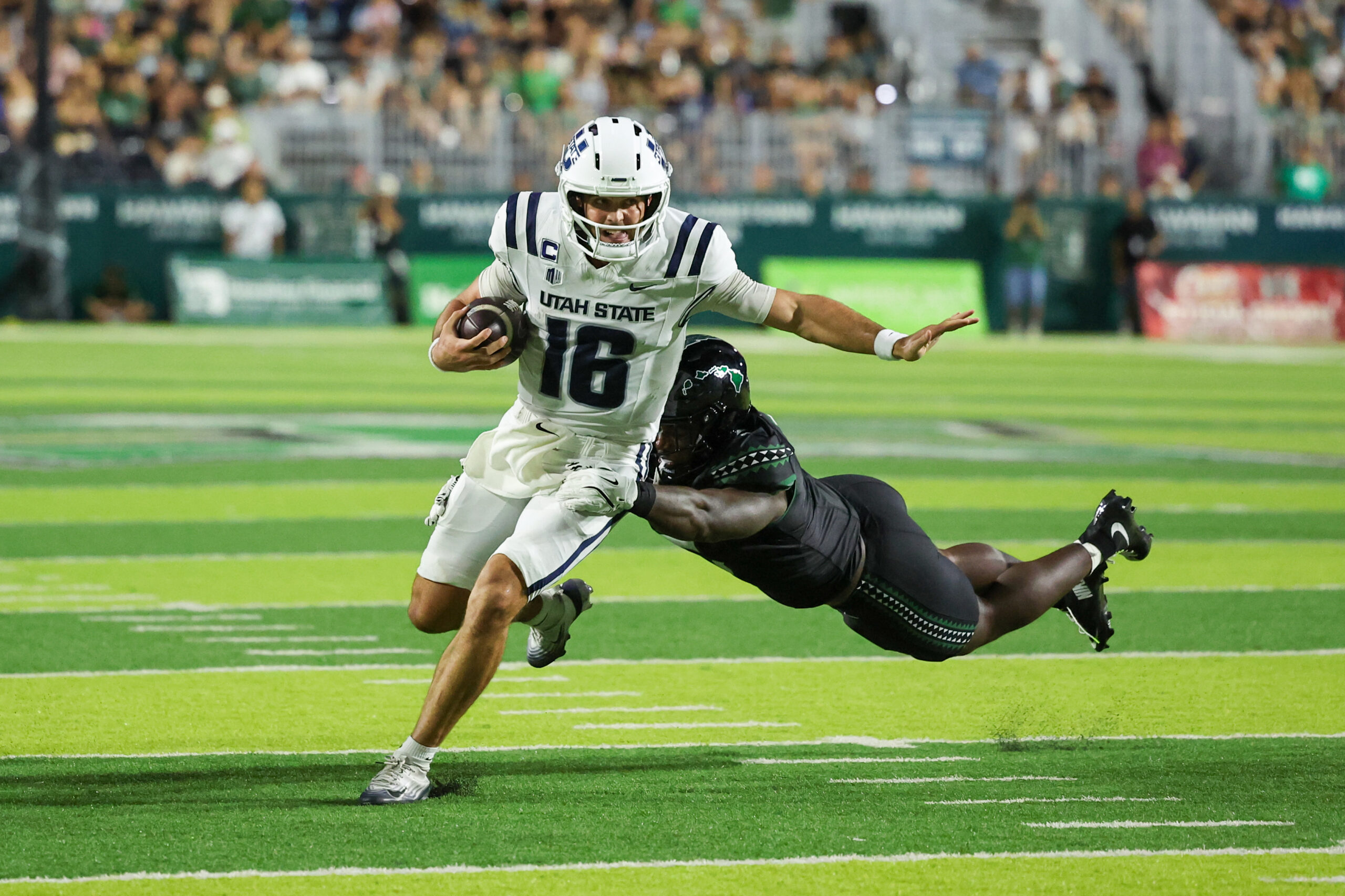 Oct 11, 2025; Honolulu, Hawaii, USA;  Hawaii Rainbow Warriors defensive lineman Tariq Jones (5) dives at Utah State Aggies quarterback Bryson Barnes (16) during the first half at Clarence T.C. Ching Athletics Complex. Mandatory Credit: Marco Garcia-Imagn Images