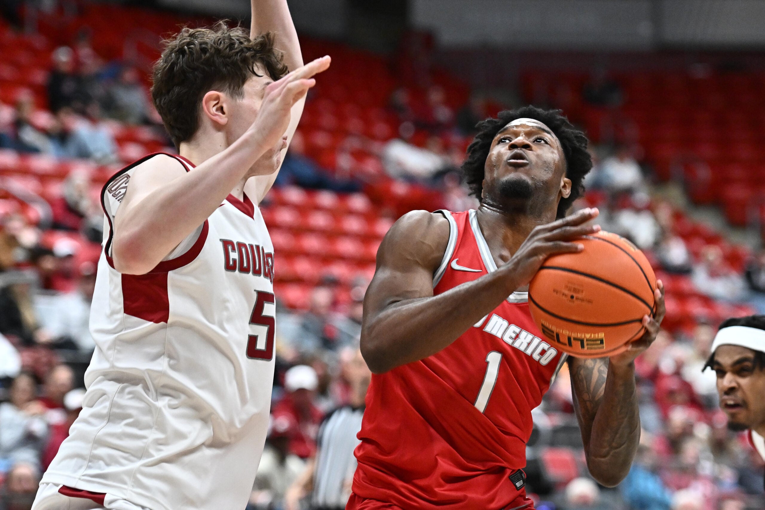 Oct 25, 2025; Pullman, WA, USA; New Mexico Lobos guard Deyton Albury (1) shoots the ball against Washington State Cougars guard Tomas Thrastarson (5) in the second half at Friel Court at Beasley Coliseum. Mandatory Credit: James Snook-Imagn Images