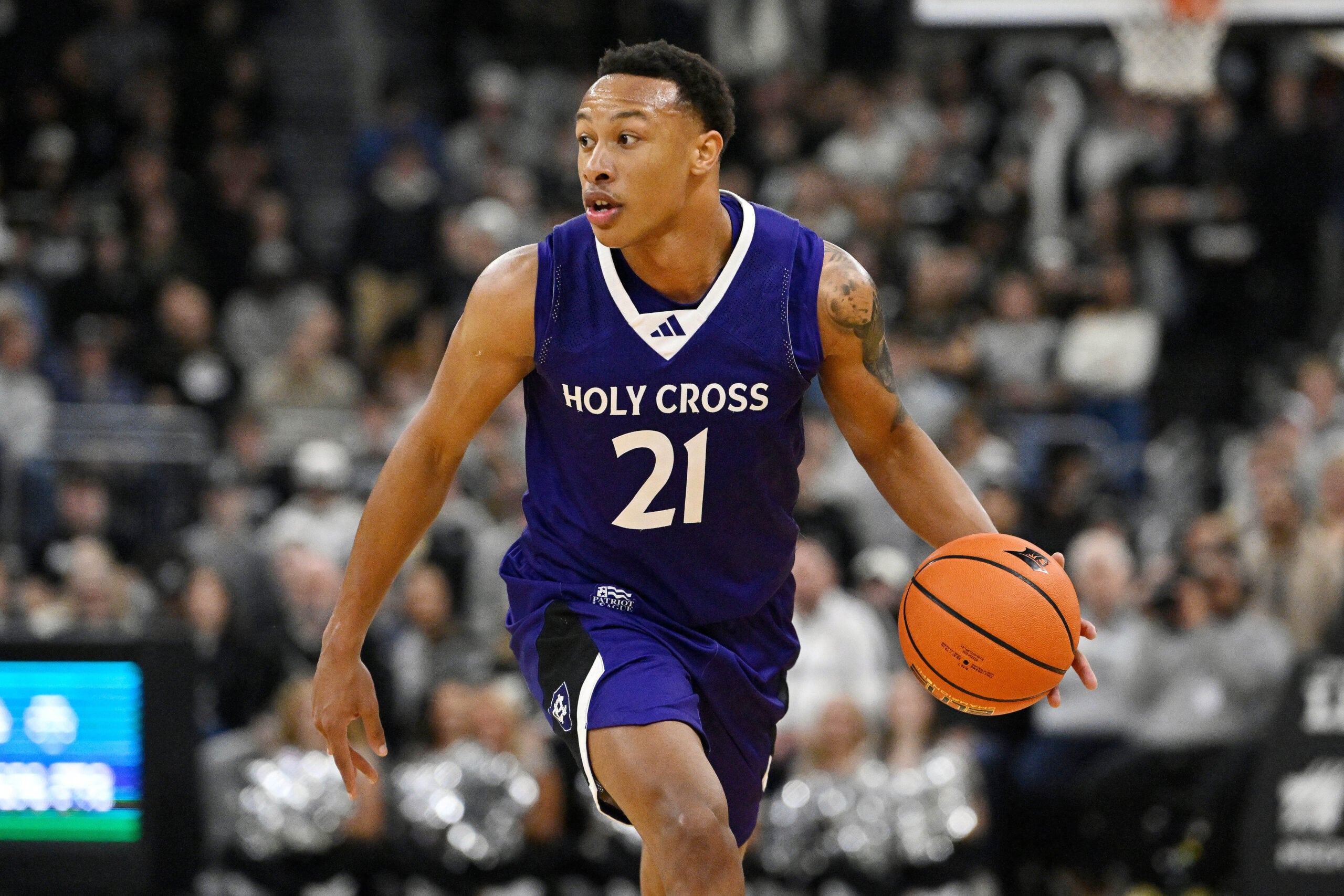 Nov 3, 2025; Providence, Rhode Island, USA; Holy Cross Crusaders guard Gabe Warren (21) dribbles the ball during the second half against the Providence Friars at Amica Mutual Pavilion. Mandatory Credit: Eric Canha-Imagn Images