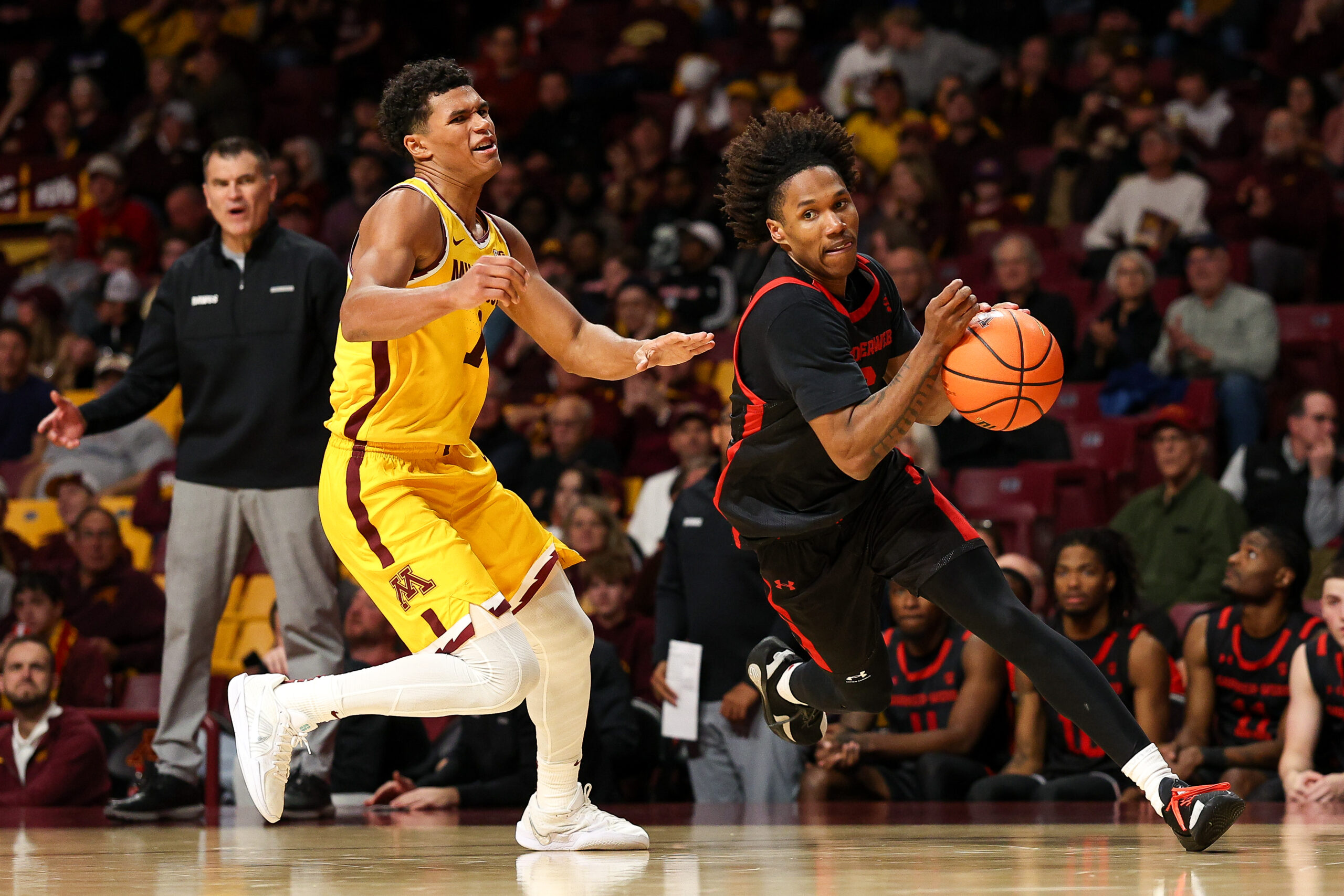 Nov 3, 2025; Minneapolis, Minnesota, USA; Gardner-Webb Runnin' Bulldogs guard Jacob Hudson (6) works around Minnesota Golden Gophers guard Isaac Asuma (1) during the second half at Williams Arena. Mandatory Credit: Matt Krohn-Imagn Images