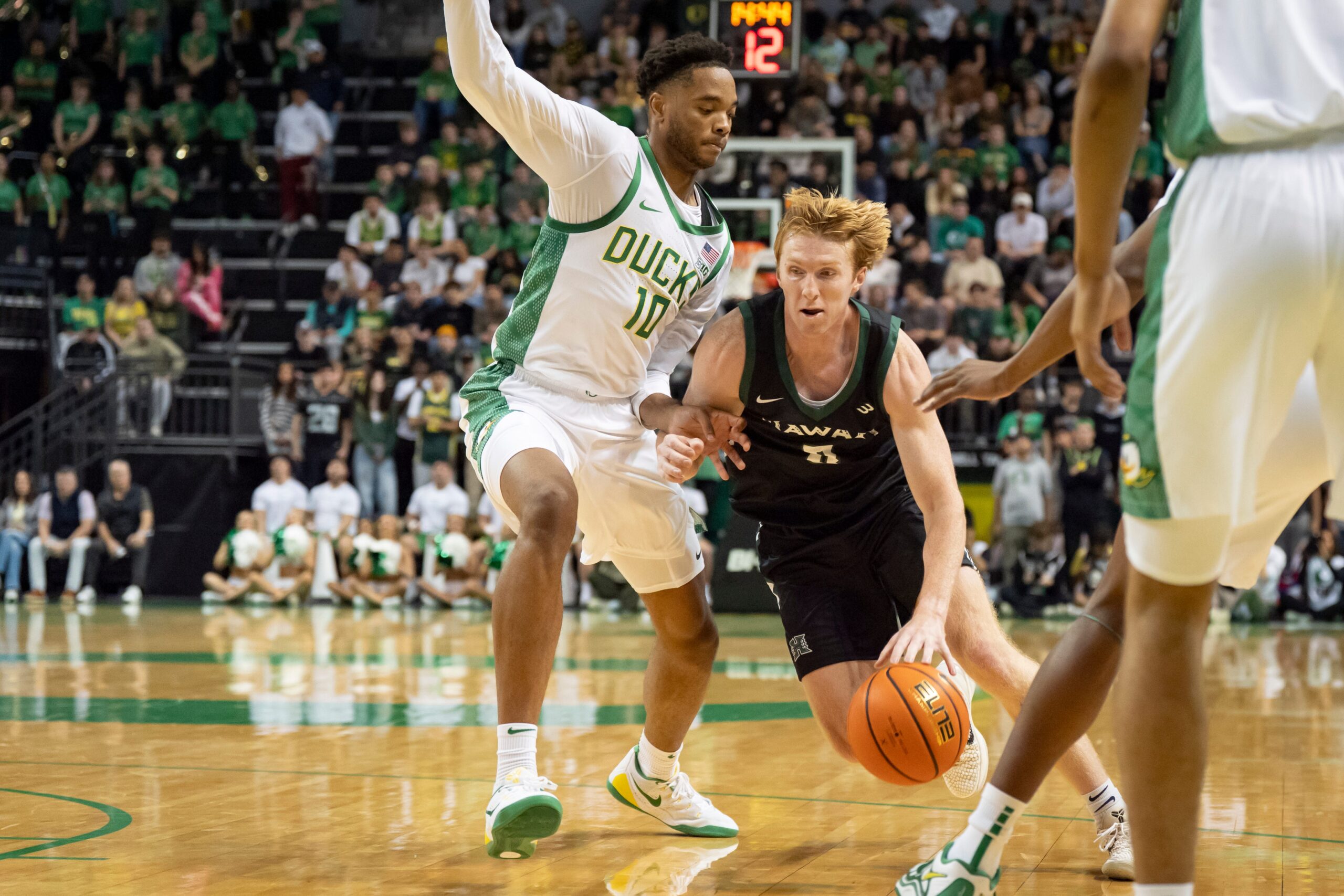 Hawaii guard Hunter Erickson, right, drives past Oregon forward Kwame Evans Jr. as the Oregon Ducks host the Hawaii Rainbow Warriors on Nov. 4, 2025, at Matthew Knight Arena in Eugene, Oregon.
